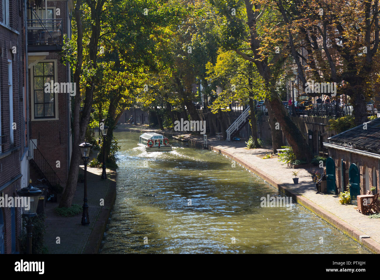 Utrecht, Netherlands - September 27, 2018:  Sightseeing boat in the canal in the historical center of Utrecht in autumn Stock Photo