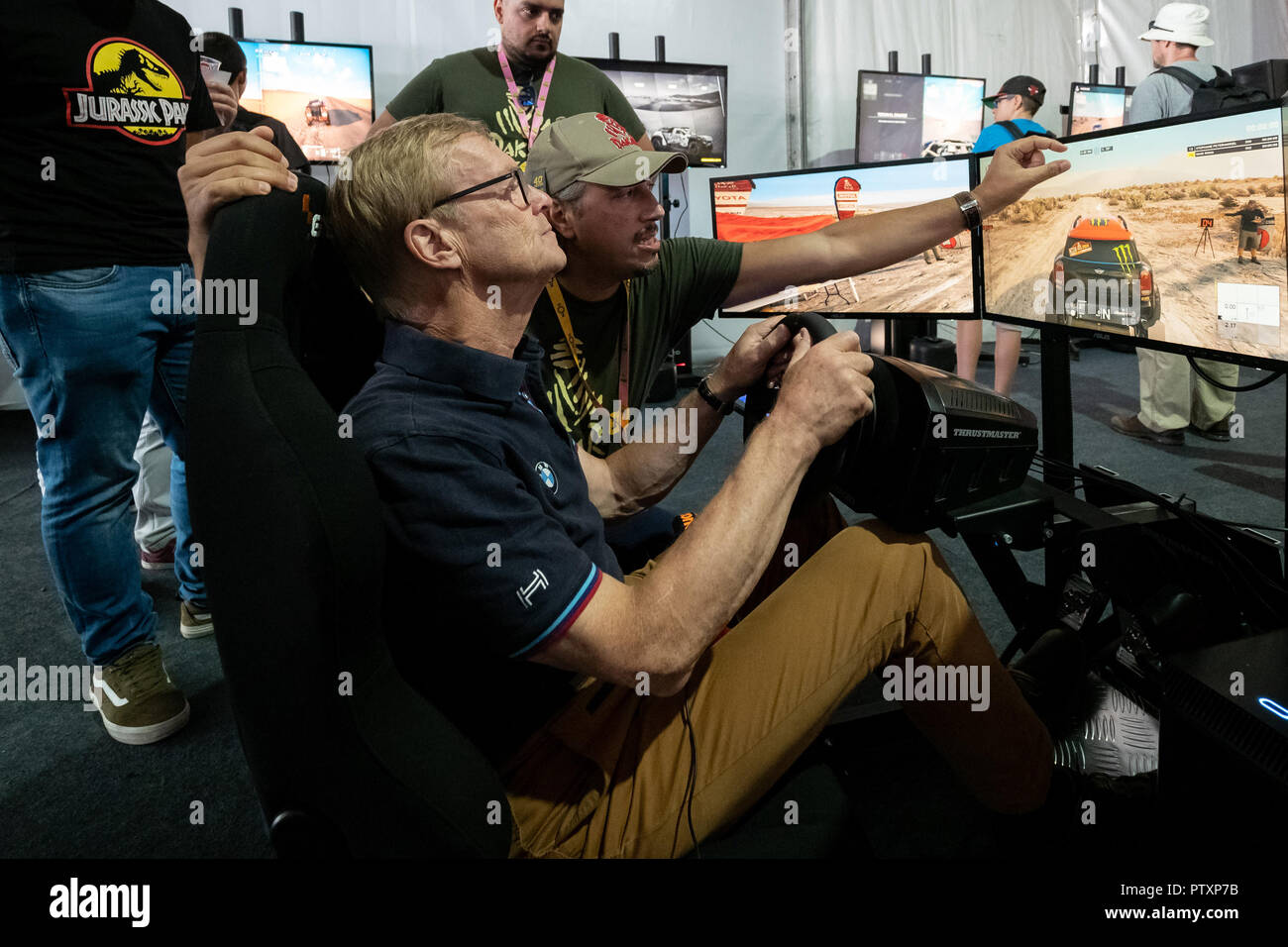 Alges, PORTUGAL: Ari Vatanen testing the portuguese game Dakar18 with Paulo Gomes CEO and Director of Bigmoon Entertainment on 4th and last day of Comic Con Portugal 2018 in Passeio Maritimo de Alges in Alges, Sunday, Sep. 9, 2018. Due to be released on Sep. 11 on PlayStation 4, Xbox One, Microsoft Windows  Featuring: Ari Vatanen, Paulo Gomes Where: Algés, Oeiras, Portugal When: 09 Sep 2018 Credit: Rui M Leal/WENN.com Stock Photo