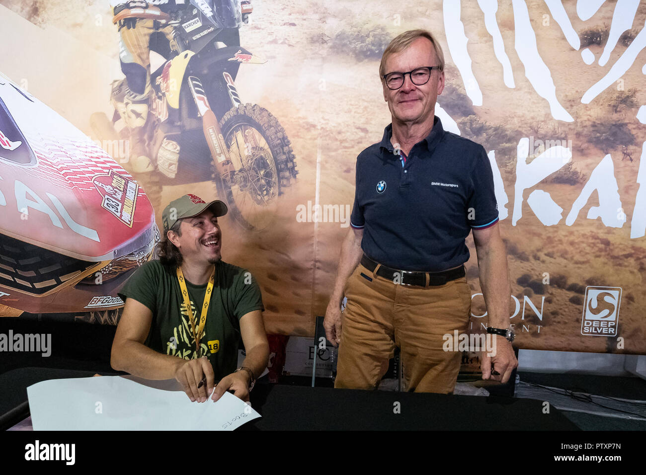 Alges, PORTUGAL: Ari Vatanen testing the portuguese game Dakar18 with Paulo Gomes CEO and Director of Bigmoon Entertainment on 4th and last day of Comic Con Portugal 2018 in Passeio Maritimo de Alges in Alges, Sunday, Sep. 9, 2018. Due to be released on Sep. 11 on PlayStation 4, Xbox One, Microsoft Windows  Featuring: Ari Vatanen, Paulo Gomes Where: Algés, Oeiras, Portugal When: 09 Sep 2018 Credit: Rui M Leal/WENN.com Stock Photo