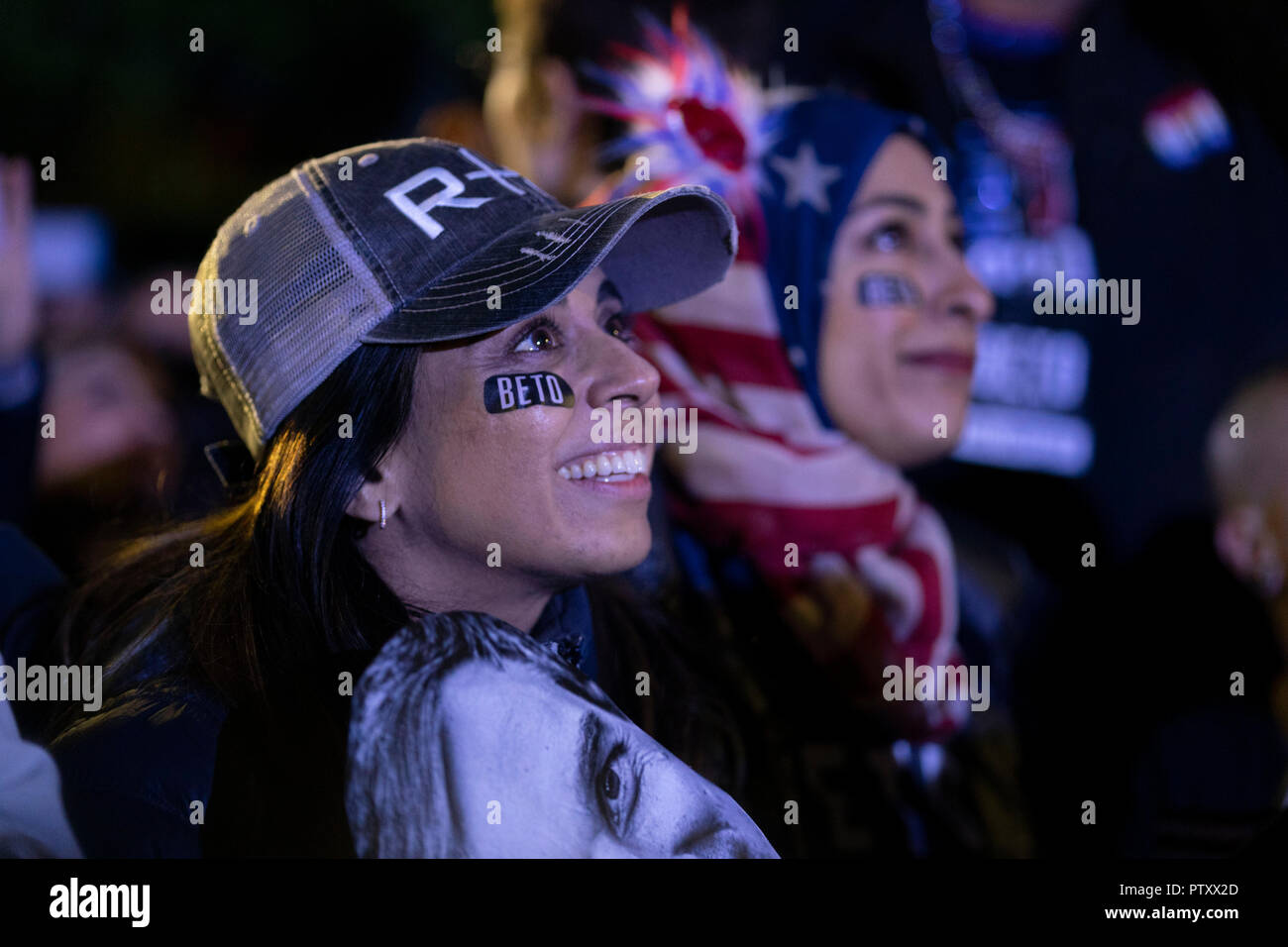Young supporter wearing Beto eye black sticker smiles as the former congressman Beto O'Rourke of El Paso, TX kicks off his presidential campaign at a late night rally in front of the Texas Capitol. Stock Photo