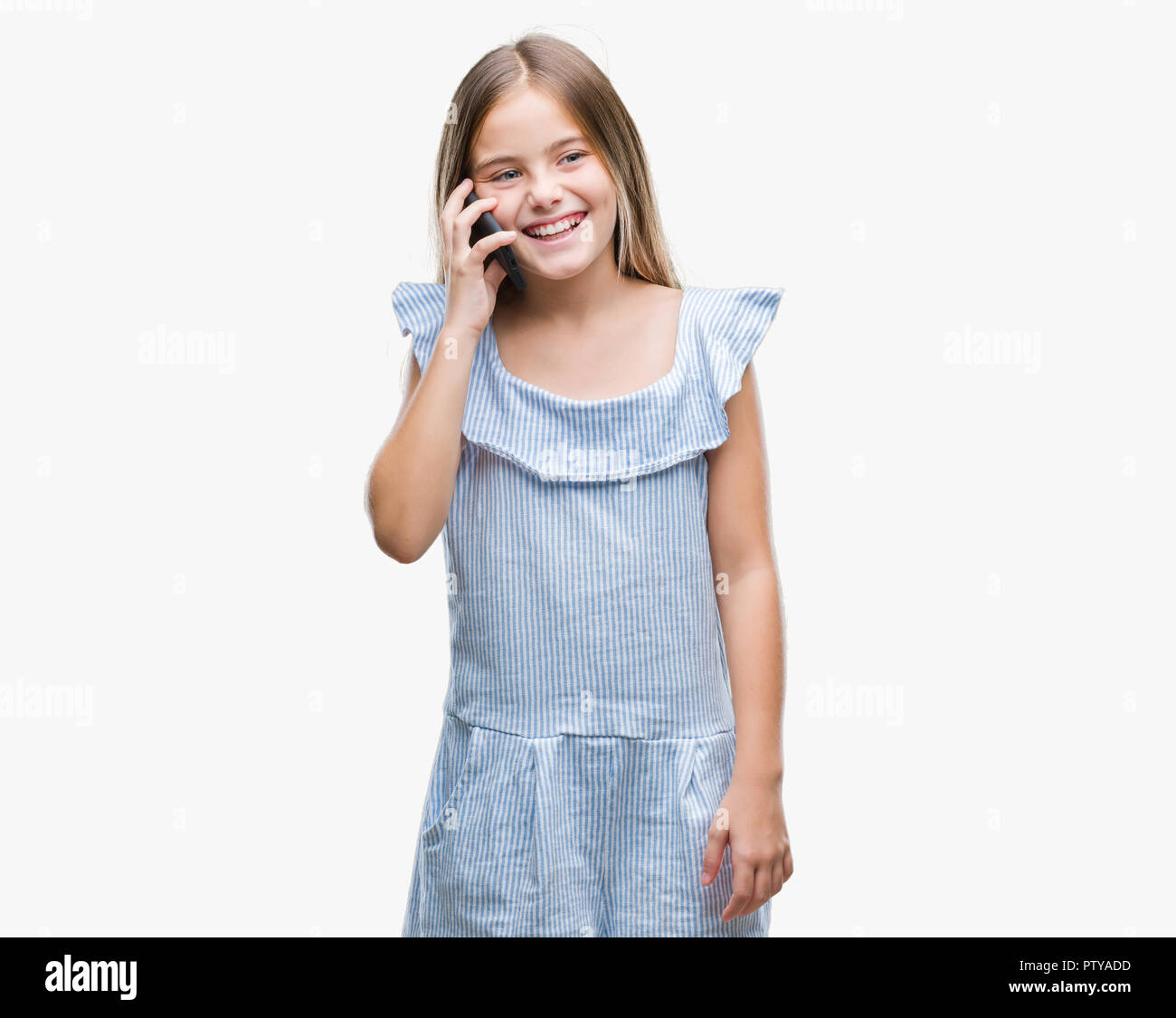 Young beautiful girl talking on the phone over isolated background with ...
