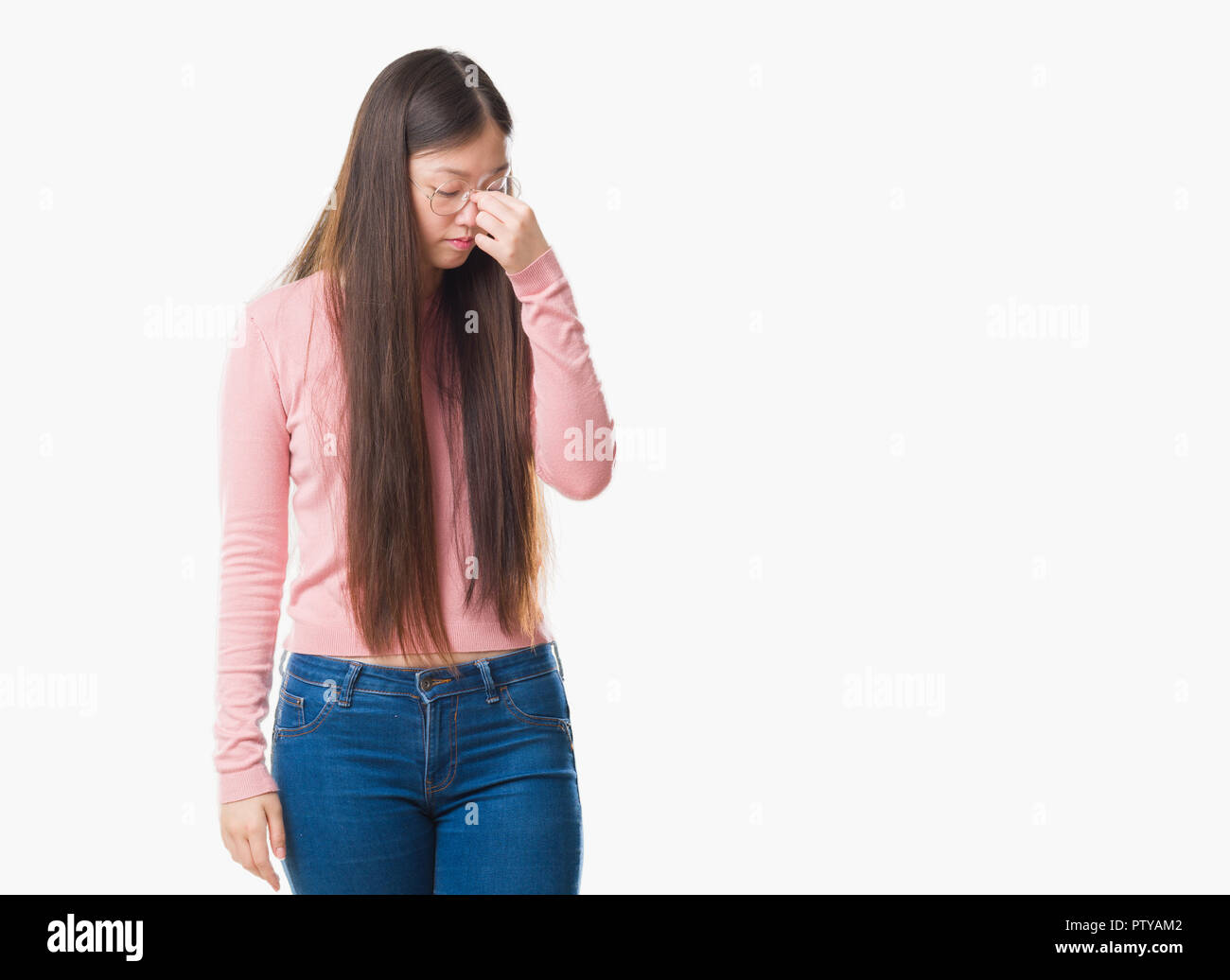 Young Chinese woman over isolated background wearing glasses tired