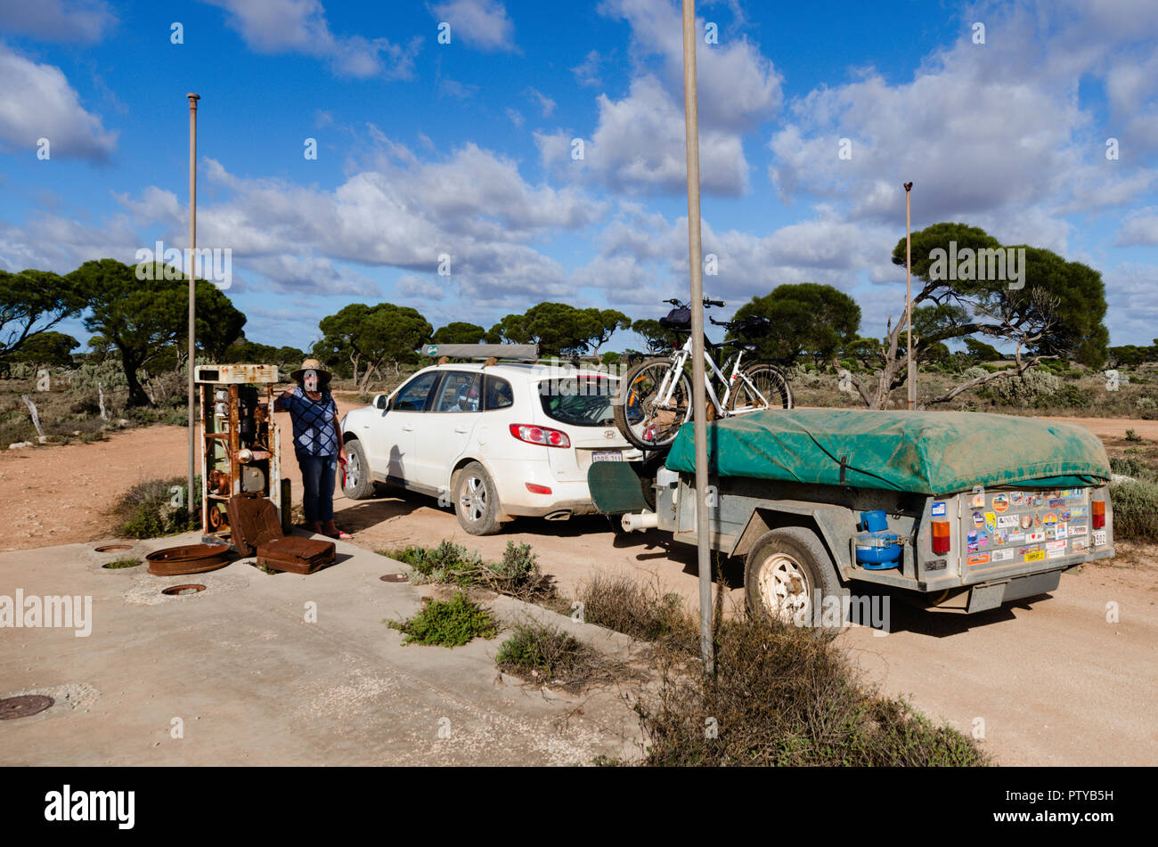 Car and camper trailer next to disused petrol bowser at the historic Koonalda Homestead, Old Eyre Highway, Nullarbor National Park South Australia Stock Photo