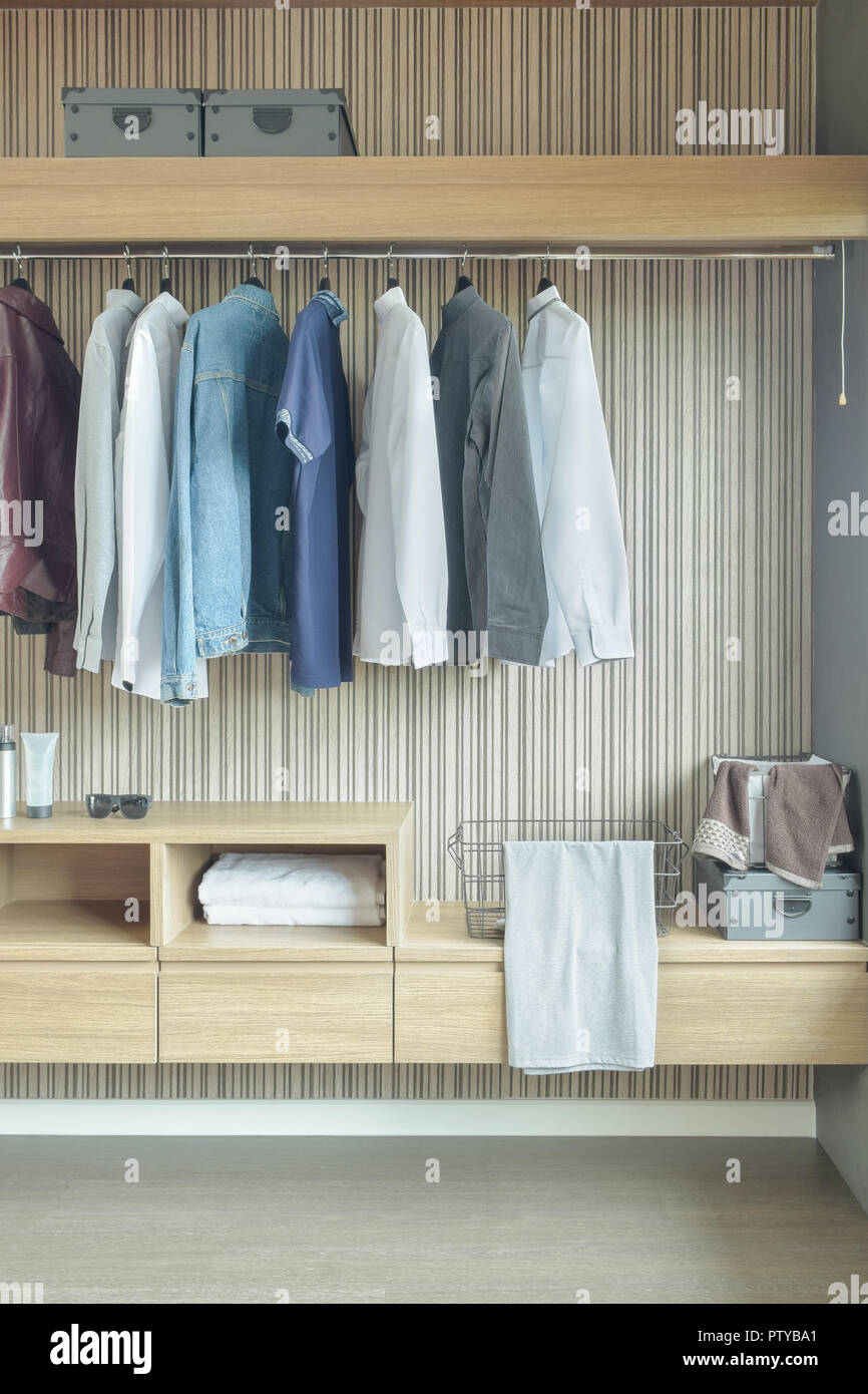 Shirts and jackets hanging in wardrobe Stock Photo