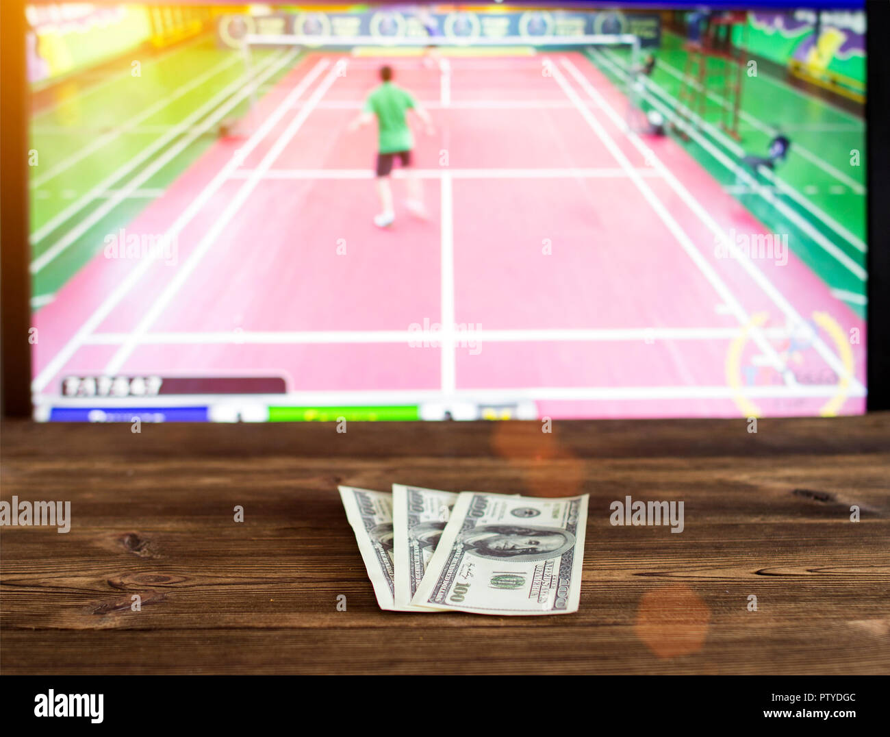 Money dollars on the background of TV on which goes badminton, betting  office, sports betting Stock Photo - Alamy