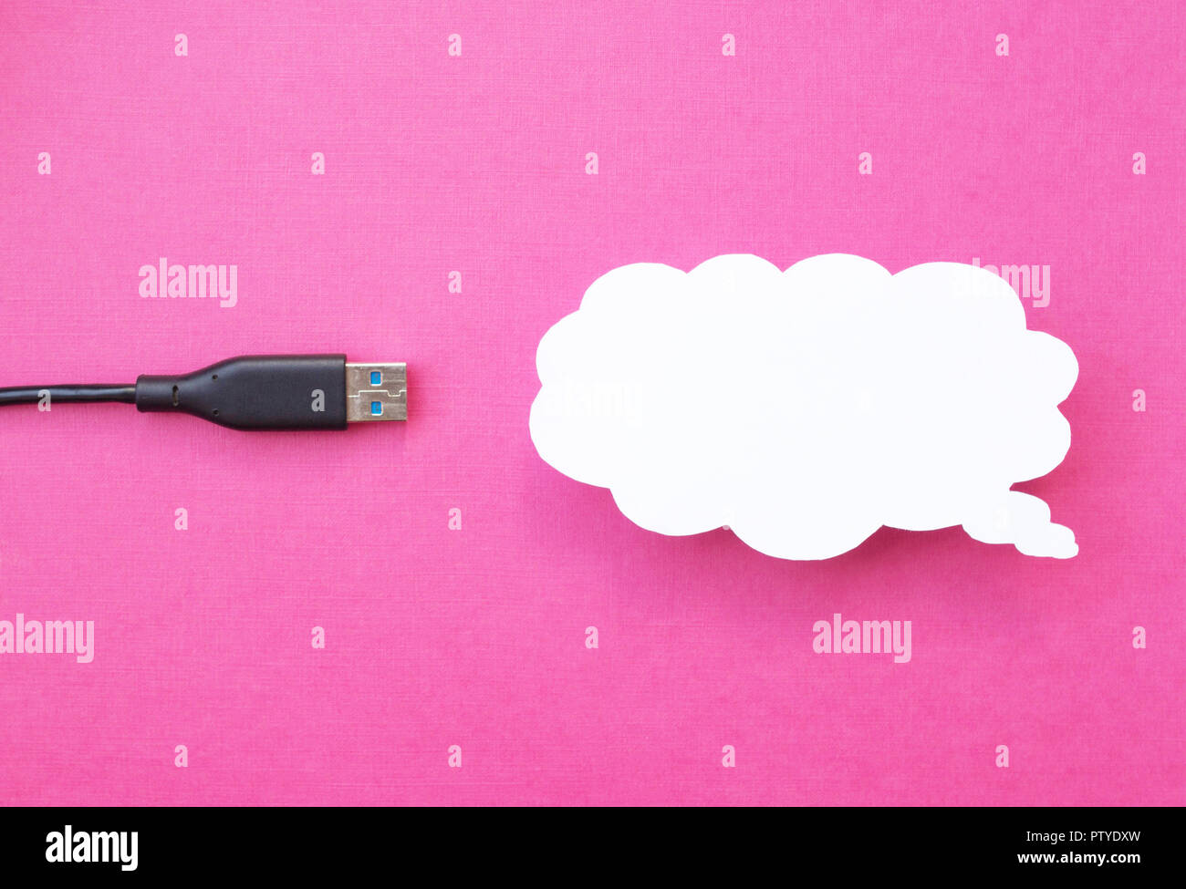Cloud for data storage cut from paper on a pink background and cable usb, close-up, data storage on the Internet Stock Photo