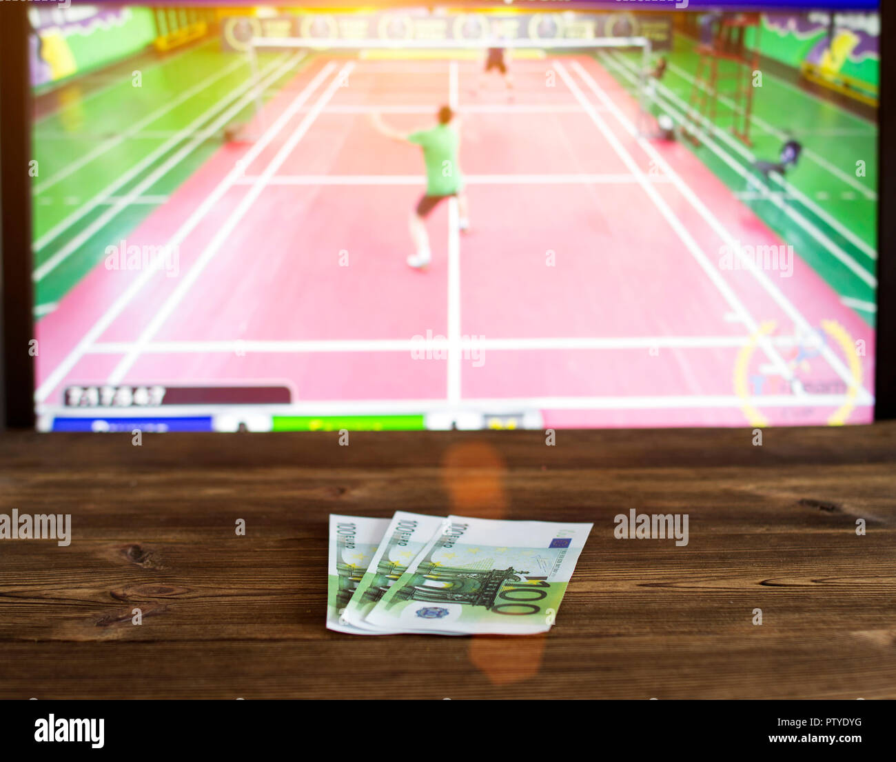 euro-money-on-the-background-of-tv-on-which-goes-badminton-betting-office-sports-betting-PTYDYG.jpg