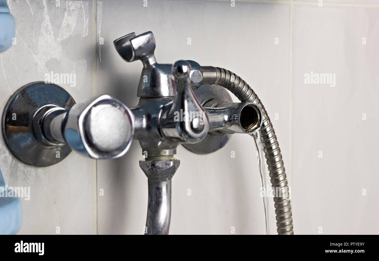 faulty water tap from which water flows Stock Photo Alamy
