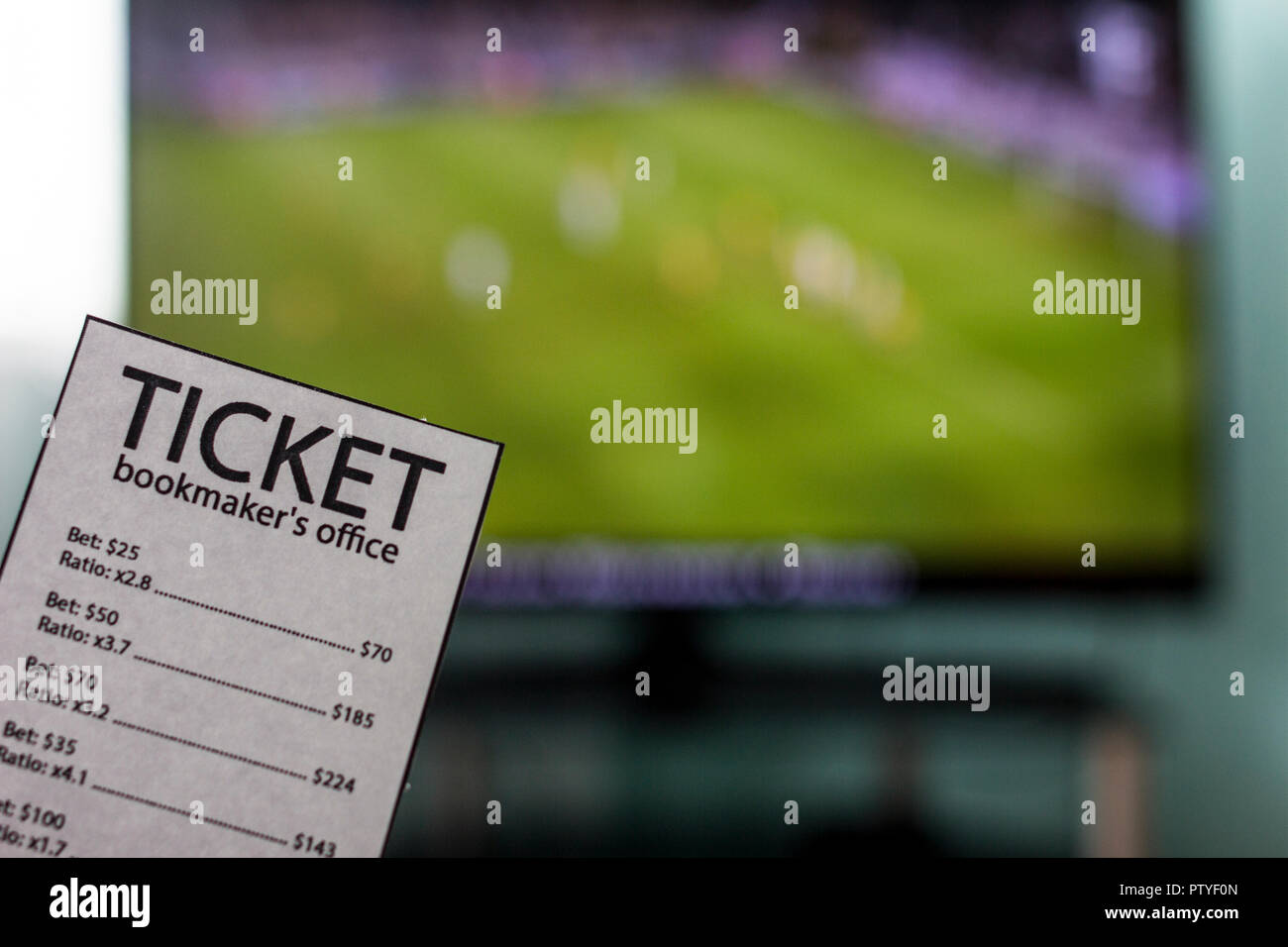 The World Cup is on the TV in the hands of a ticket office bookmaker, sports betting, close-ups Stock Photo