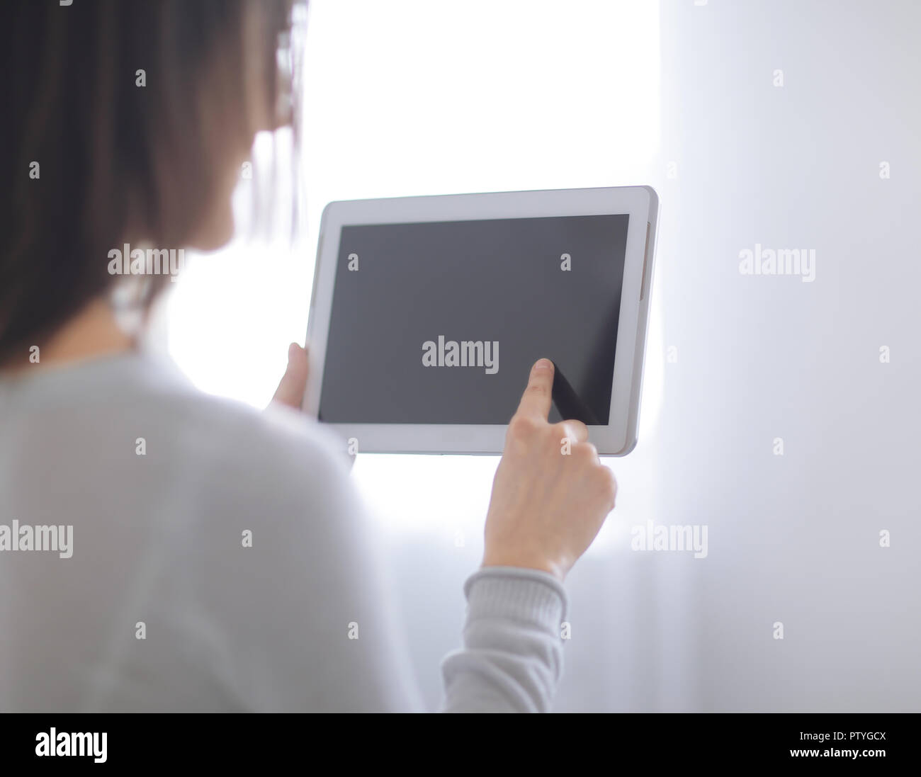 close up. woman pressing her finger on the digital tablet screen .photo with copy space Stock Photo