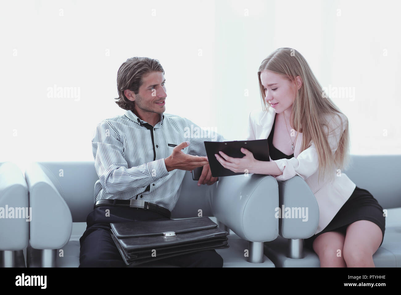 Two coworkers discussing their work, working with documents Stock Photo