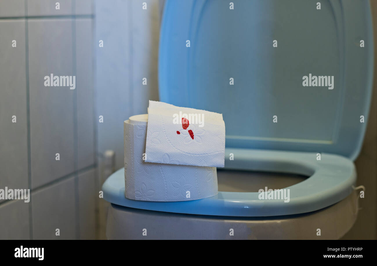 Toilet paper with blood lies on the toilet Stock Photo Alamy