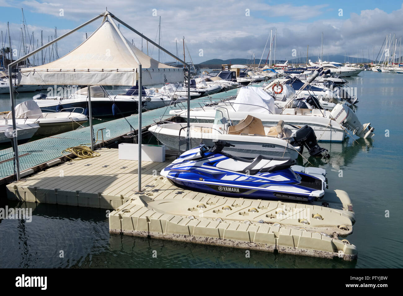 Double PWC personal watercraft jet ski floating dock with one jet ski in place Port of Alghero, Alghero, Sardinia, Italy Stock Photo