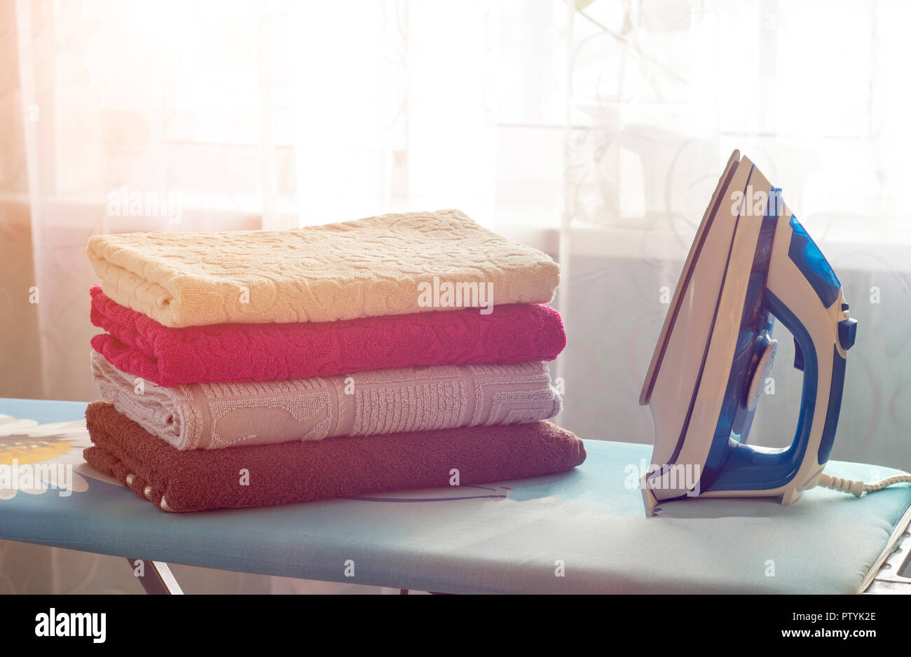 Iron, ironing board and towels Stock Photo Alamy