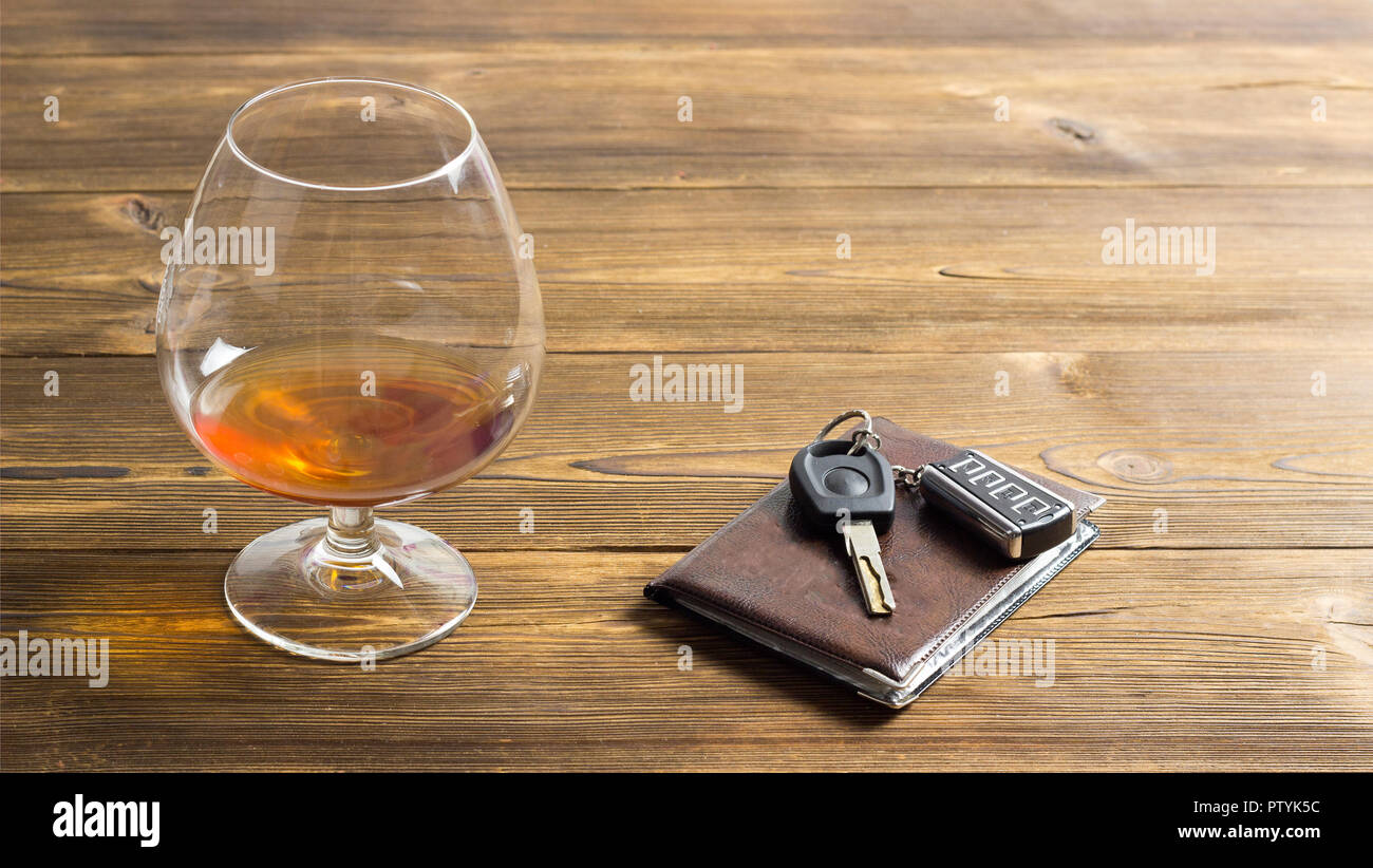 Car keys, alcohol and driver's license, wooden background Stock Photo