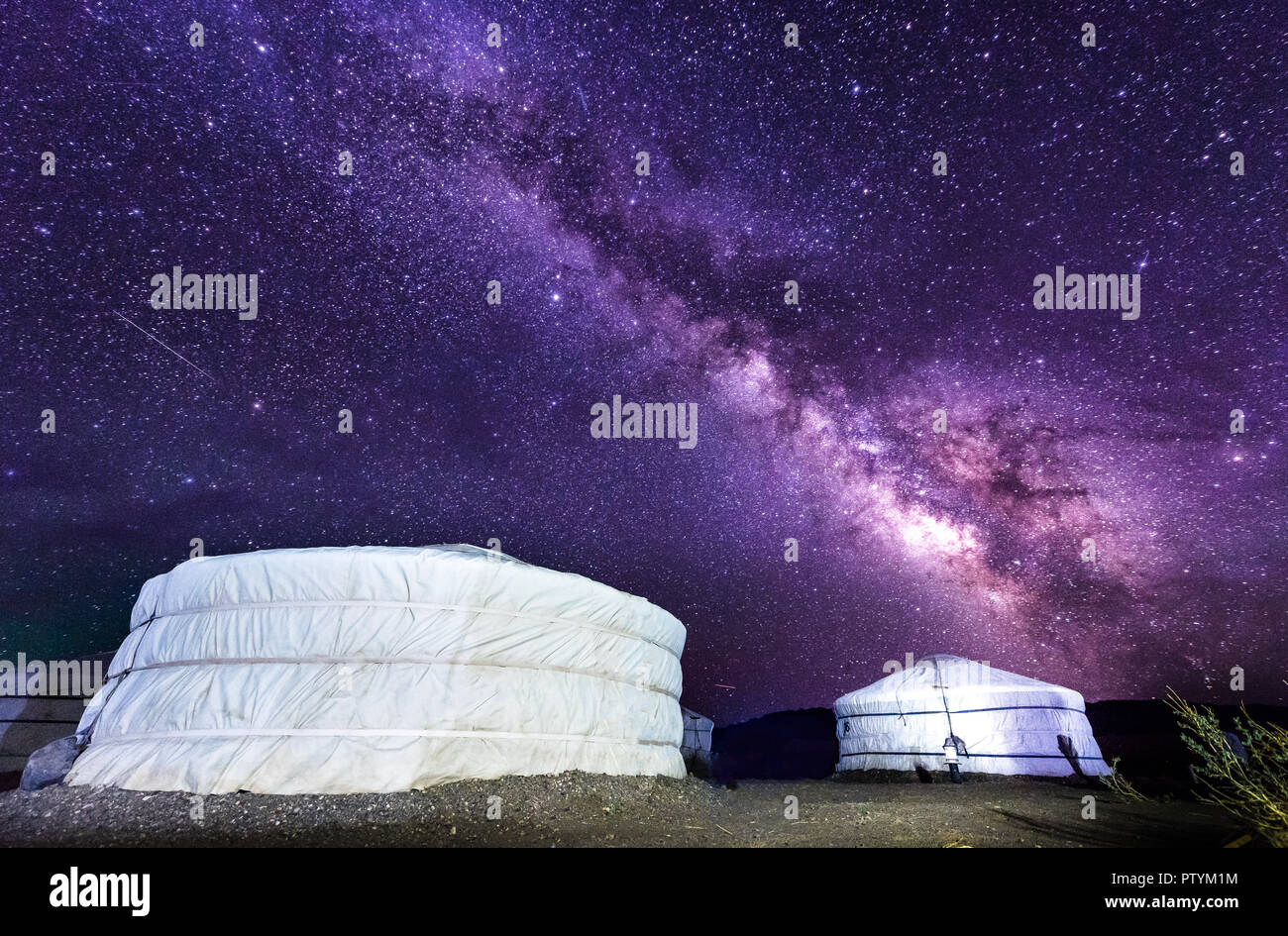 Milky way over ger camp in Mongolia gobi desert. Millions of stars in the sky at night in Mongol desert at a ger tent camp. Beautiful night sky with s Stock Photo