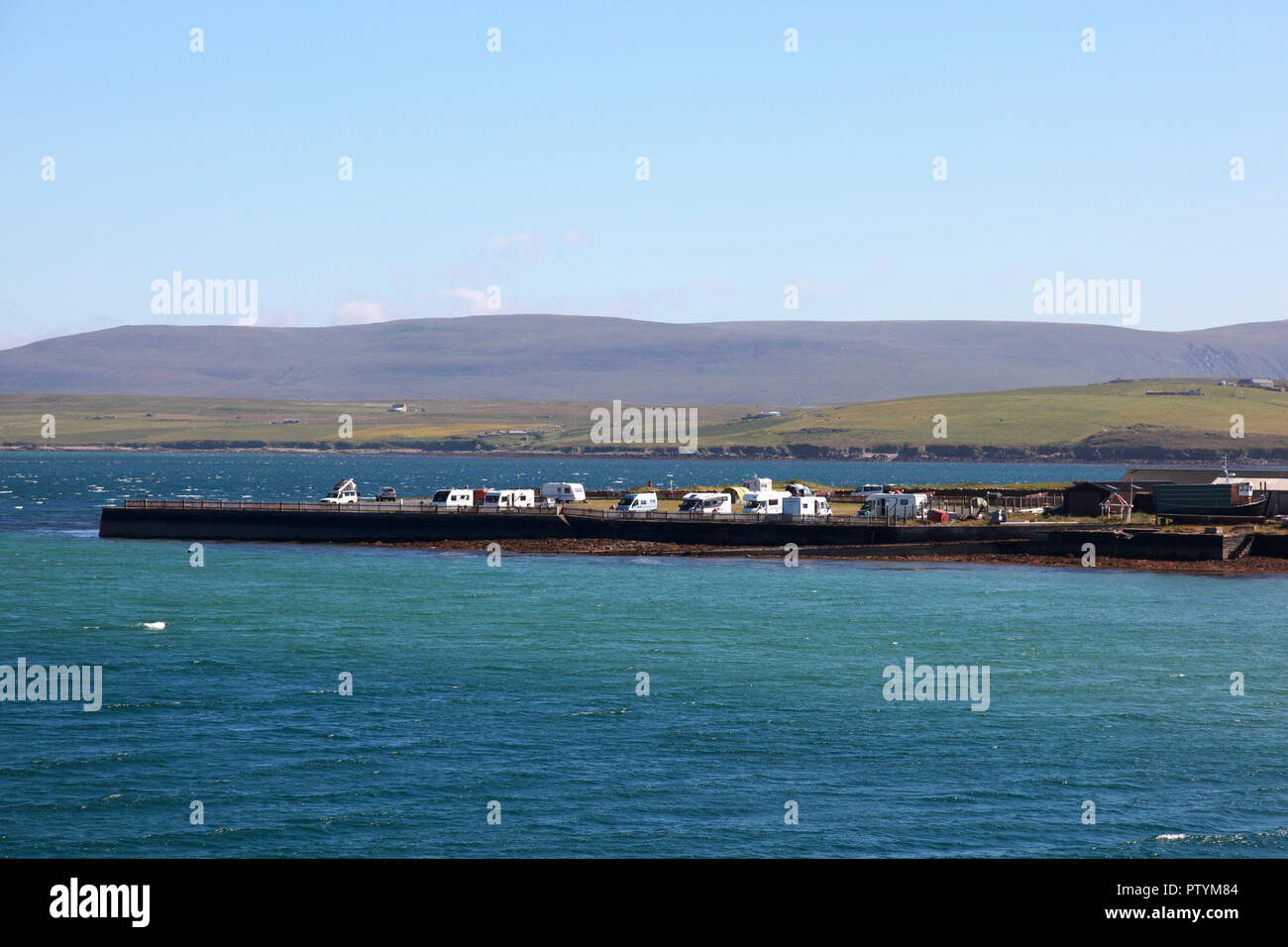 A campsite and caravan site at the Point of Ness, Stromness, Orkney, looking towards Graemsay and the hills of Hoy Stock Photo