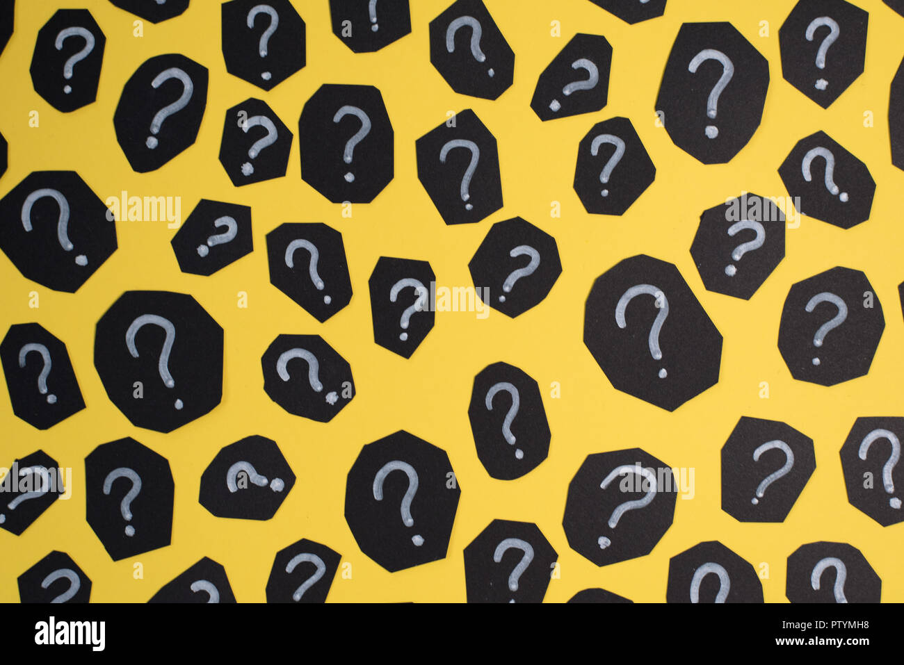 full frame image of black paper card with QUESTION MARK on yellow background. Concept of FAQ, Q&A, Problems and Questions background Stock Photo
