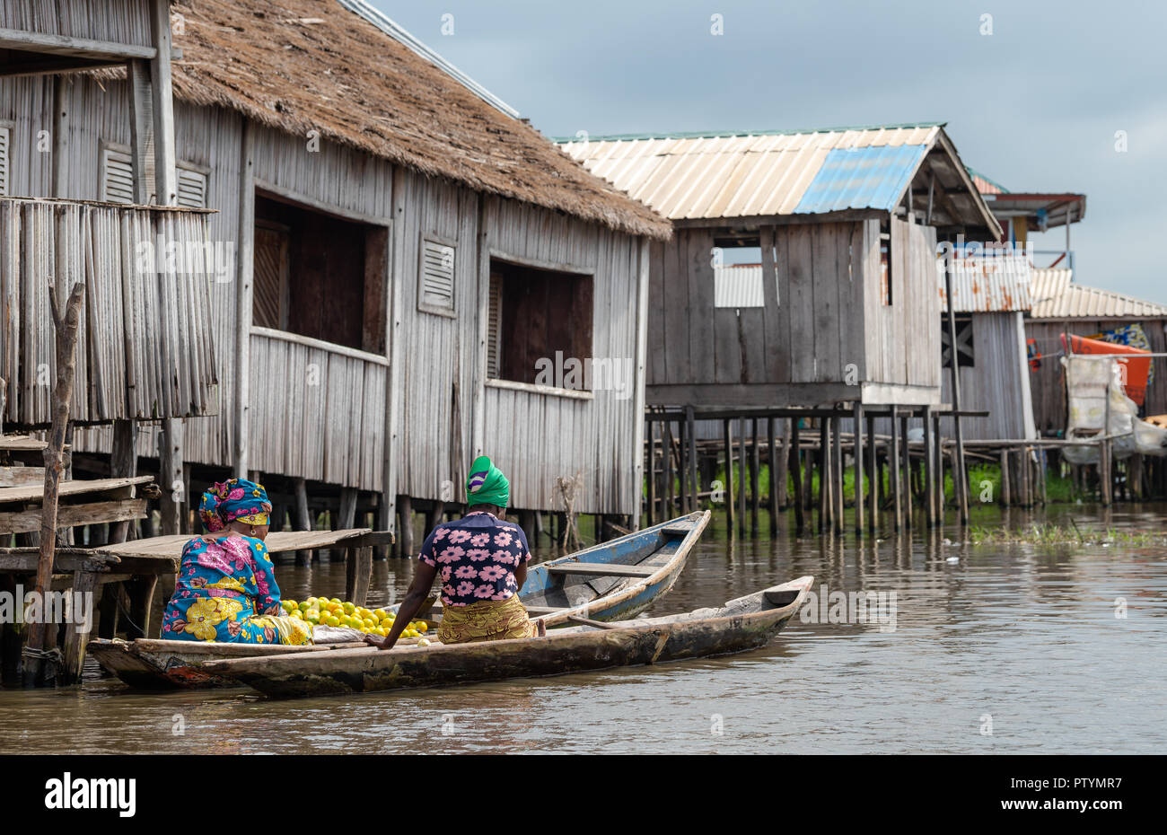 Lake house and boat. Benin lake Nokoué lifestyle African villager living on house in water. Trading with barter system. West-Africa life in Benin livi Stock Photo