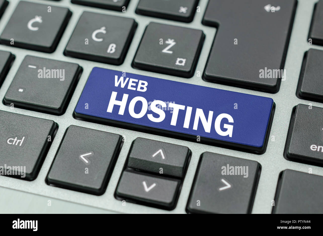 Blue Web hosting button on computer keyboard. Stock Photo