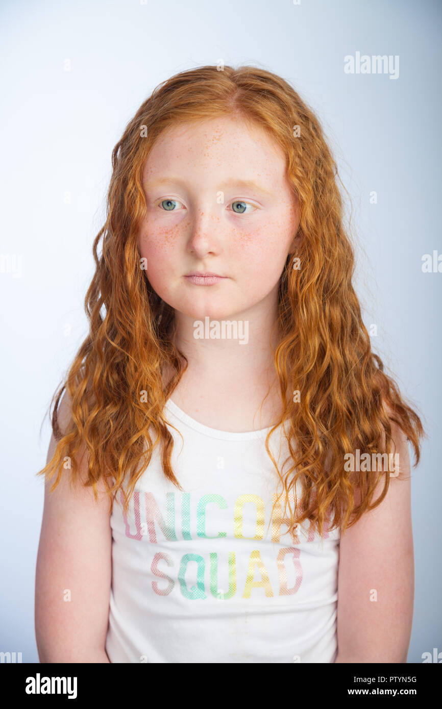 Portrait of a 10 year old girl with ginger hair and freckles. Stock Photo