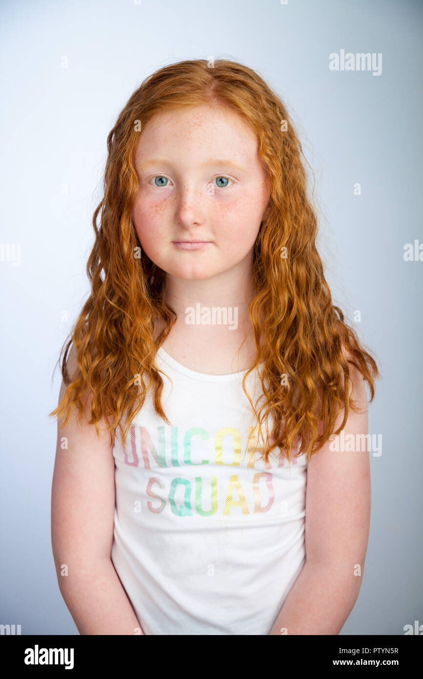 Portrait of a 10 year old girl with ginger hair and freckles. Stock Photo