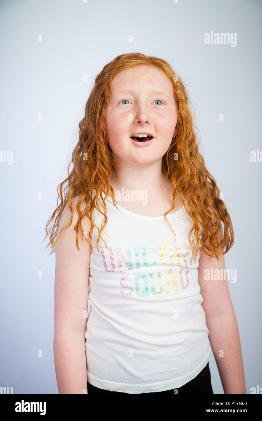 Portrait of a 10 year old girl with ginger hair and freckles. Stock Photo