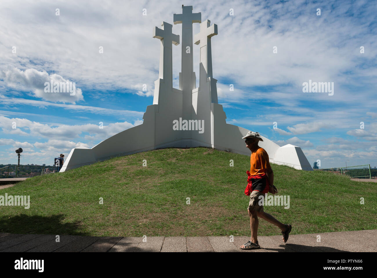 Three Crosses Hill, a tourist in Vilnius walks past three huge white crosses sited on a hill overlooking the city, Lithuania. Stock Photo