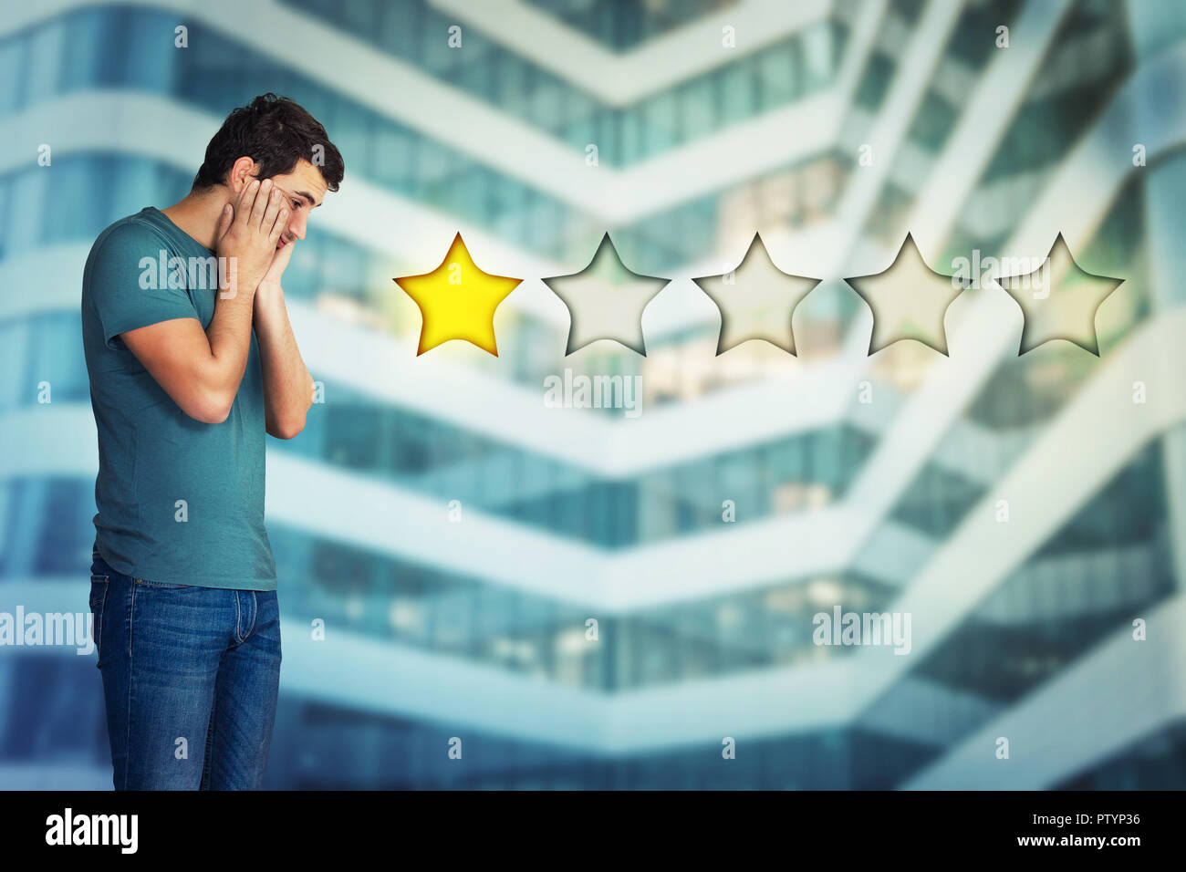 Side view of a disappointed and stressed young man hands on cheeks looking down choosing one star rating. Bad and poor customer service concept. Negat Stock Photo