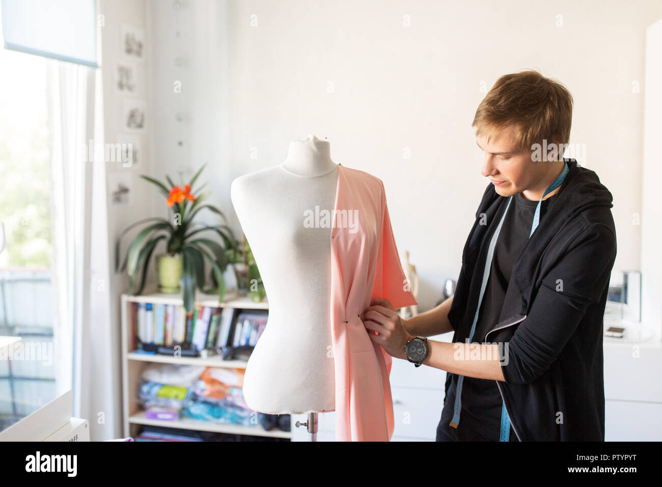 fashion designer with dummy making dress at studio Stock Photo - Alamy