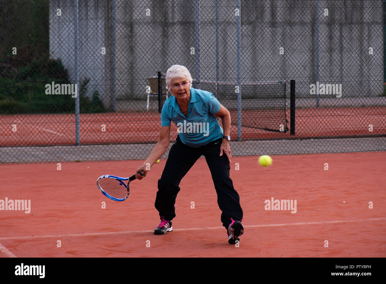 Sportive elderly woman playing tennis Stock Photo Alamy