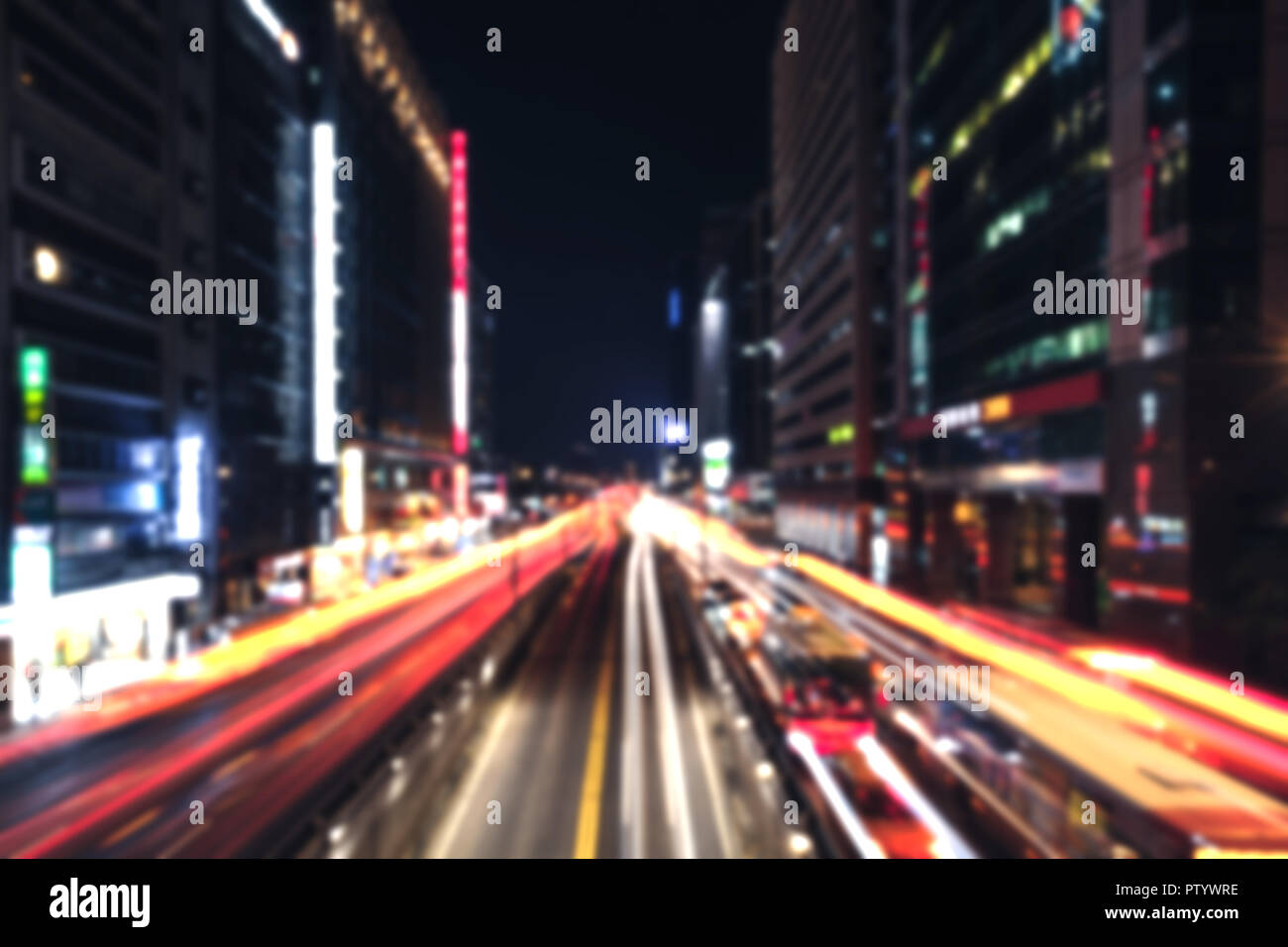 Modern cityscape at night with traffic lights on wide street. Blurred background photo Stock Photo