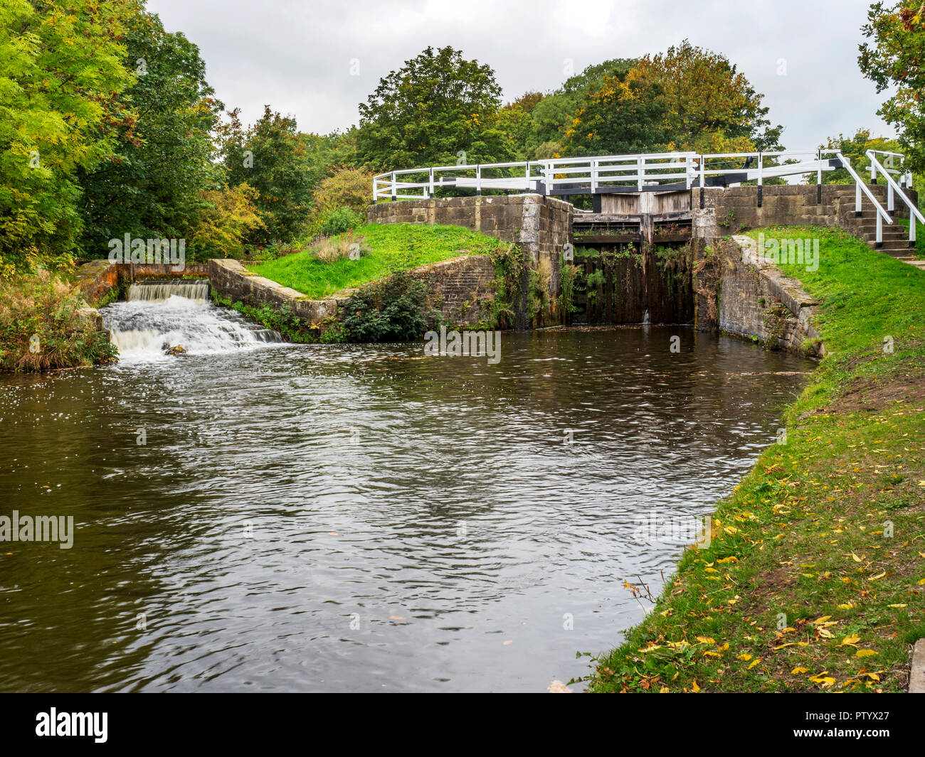 Hirst Lock and spillway on the Leeds and Liverpool Canal in early autumn near Saltaire West Yorkshire England Stock Photo
