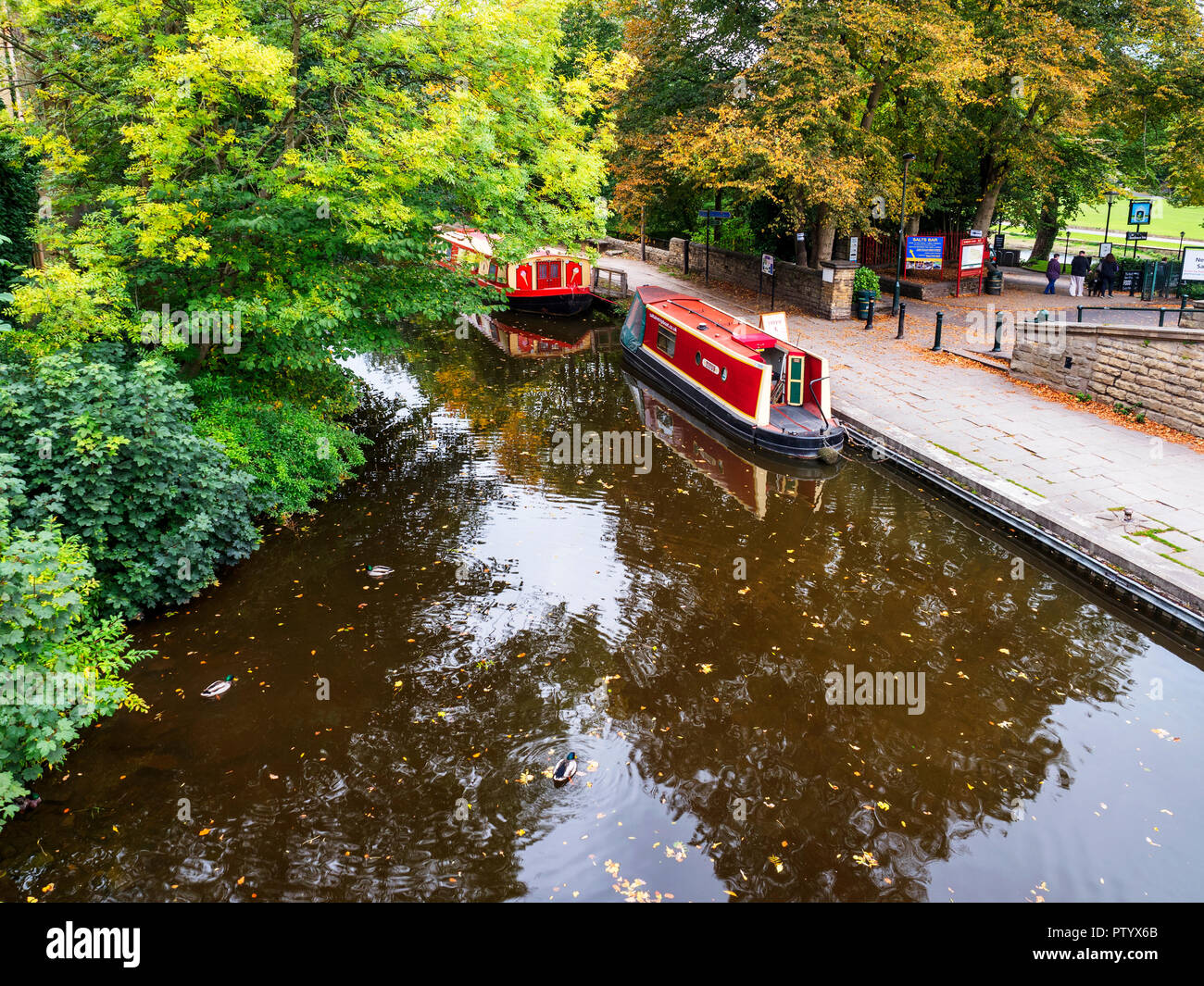 Narrowboats moored on the Leeds and Liverpool Canal at Saltaire West Yorkshire England Stock Photo