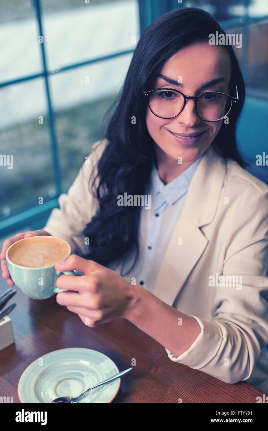 Pretty female person sitting in cafe alone Stock Photo
