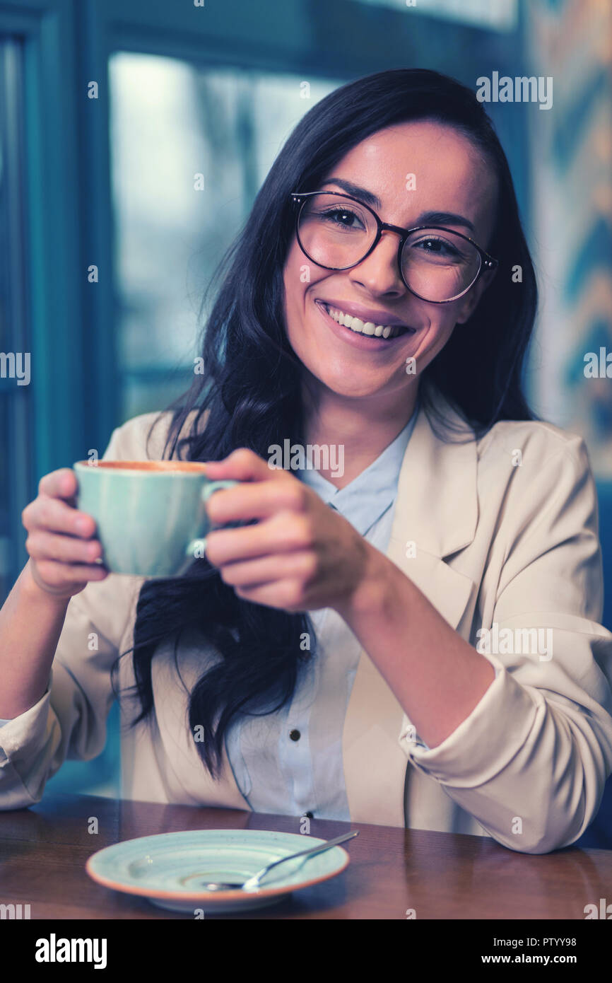 Charming girl sitting in her favorite cafeteria Stock Photo