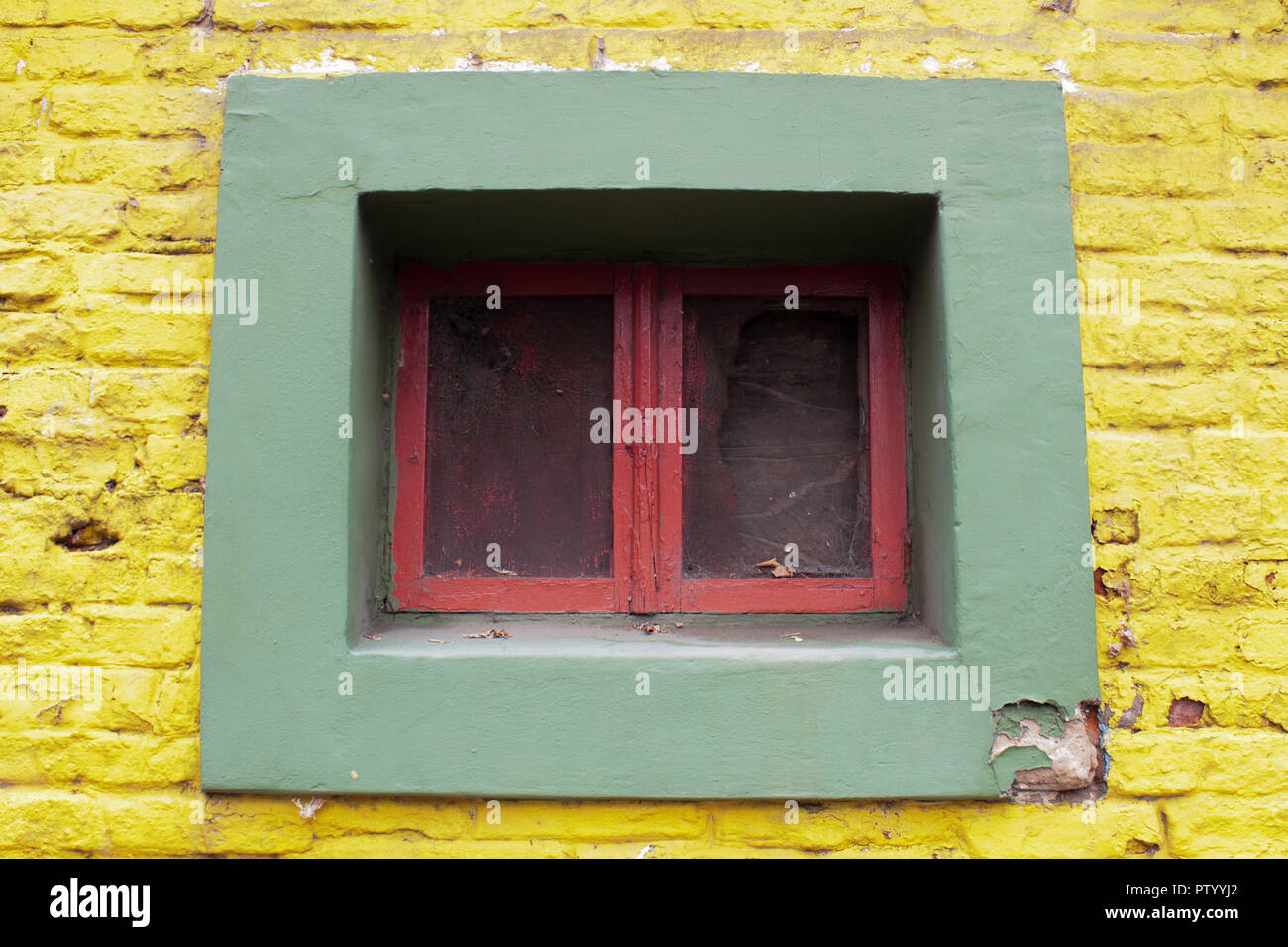 Multi color window on a brick wall Stock Photo