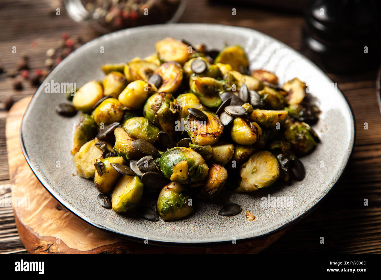 Honey roasted brussles sprouts with pumpkin seeds Stock Photo