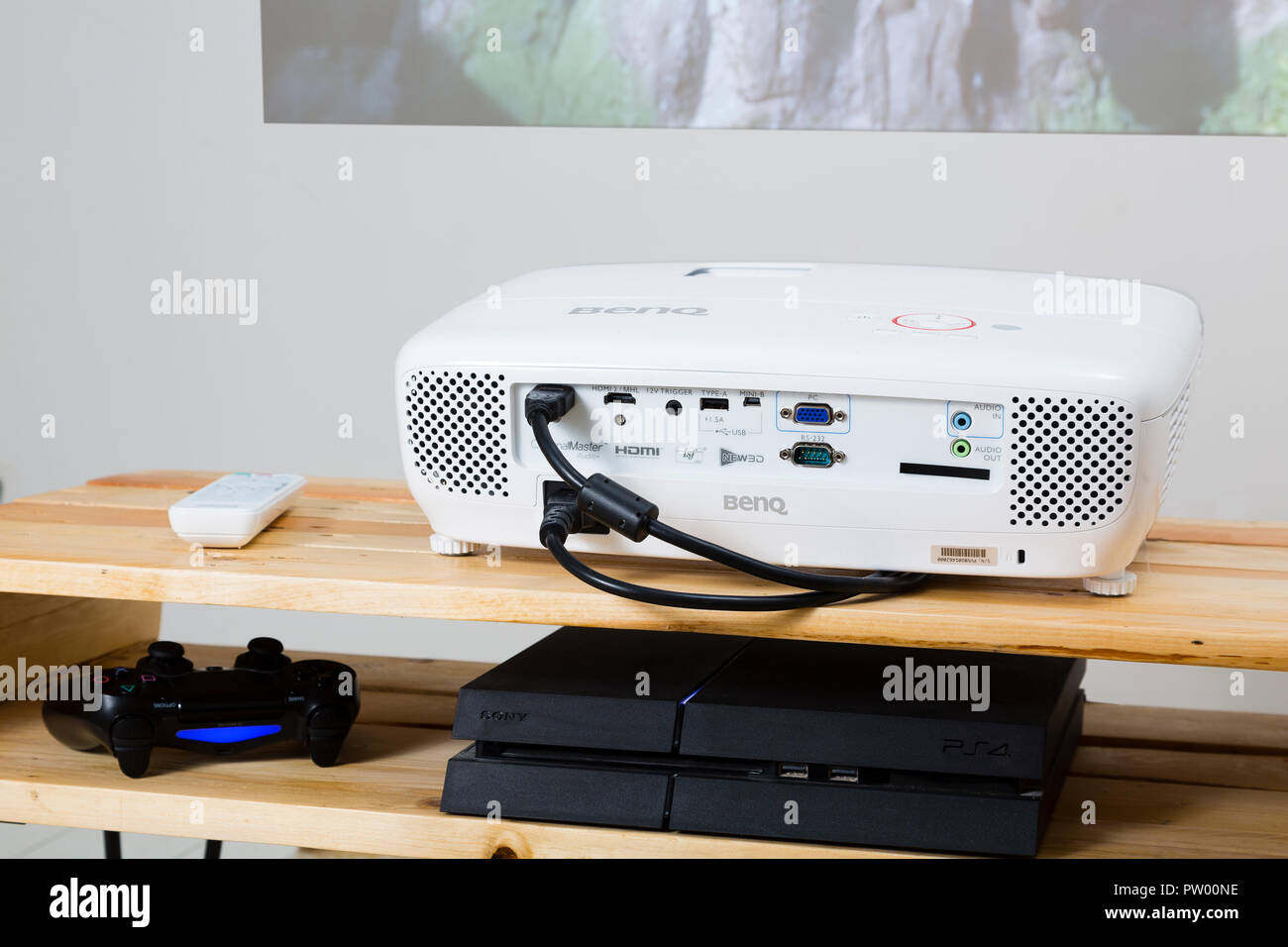 BenQ W1210ST projector playing Uncharted 4 on PlayStation 4. Stock Photo