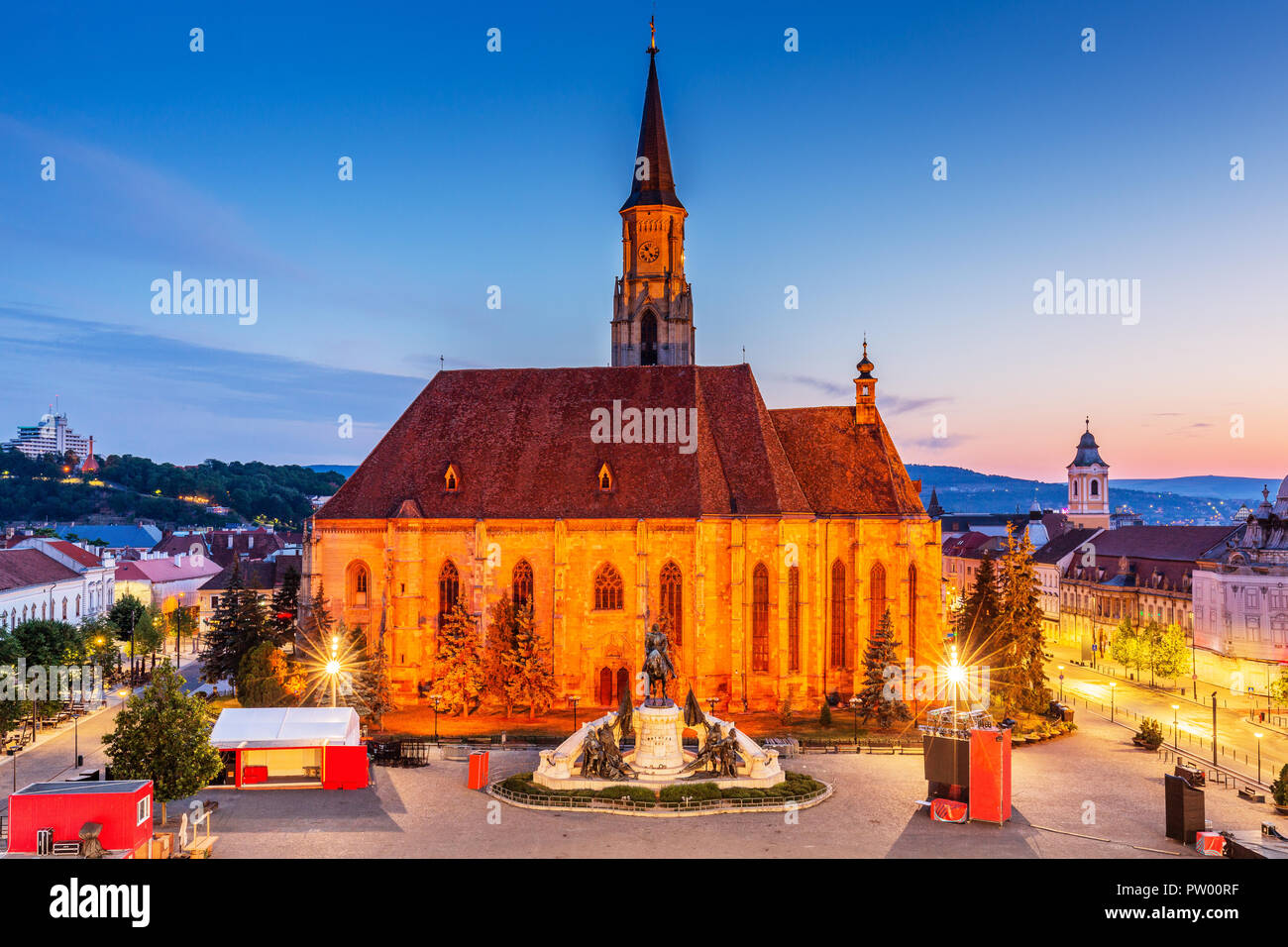 Cluj, Romania. Medieval St. Michael's Church and Union Square at sunrise. Stock Photo