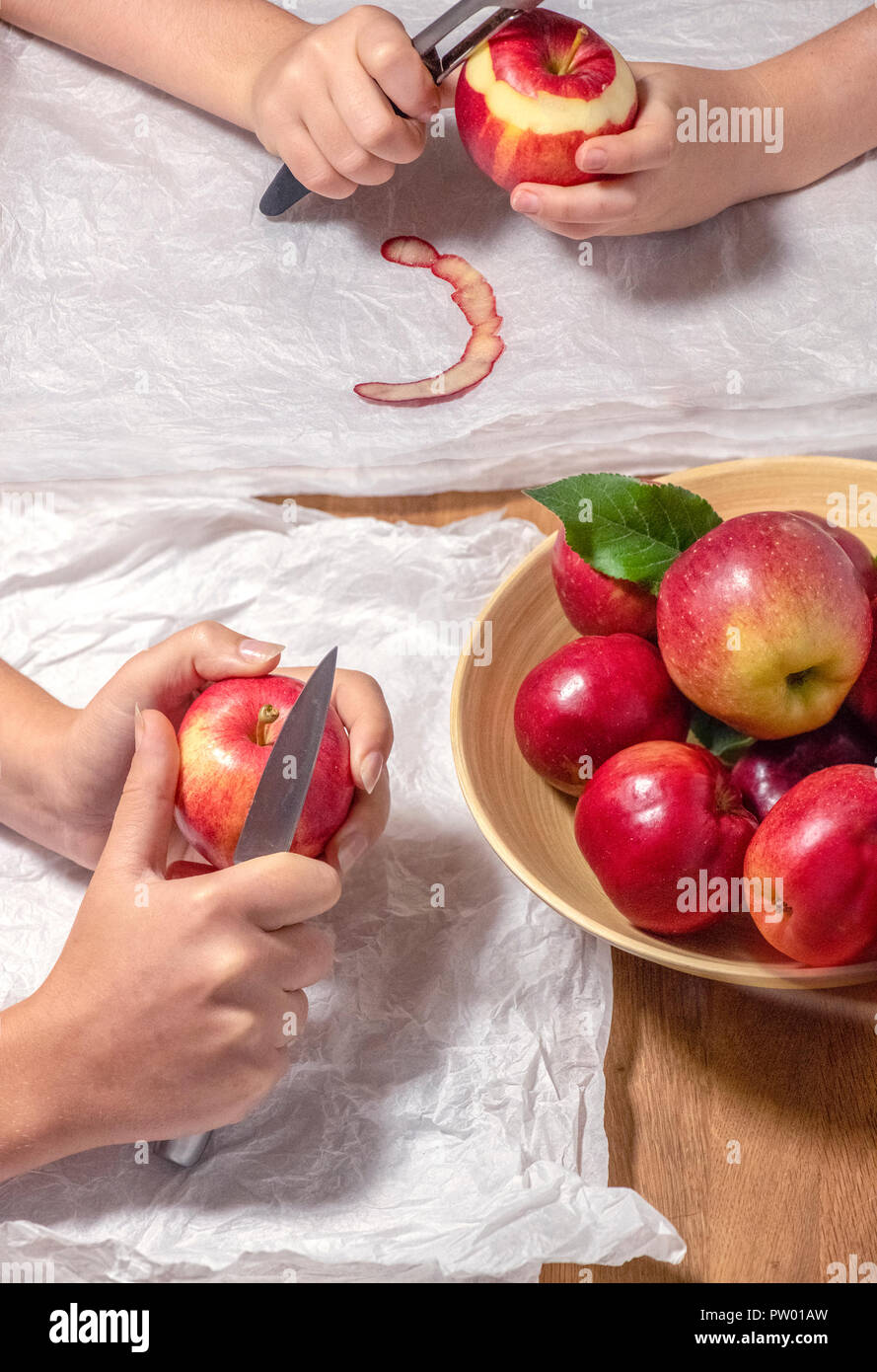 peeling freshly picked apples from the garden mother and daughter white space for text copy Stock Photo