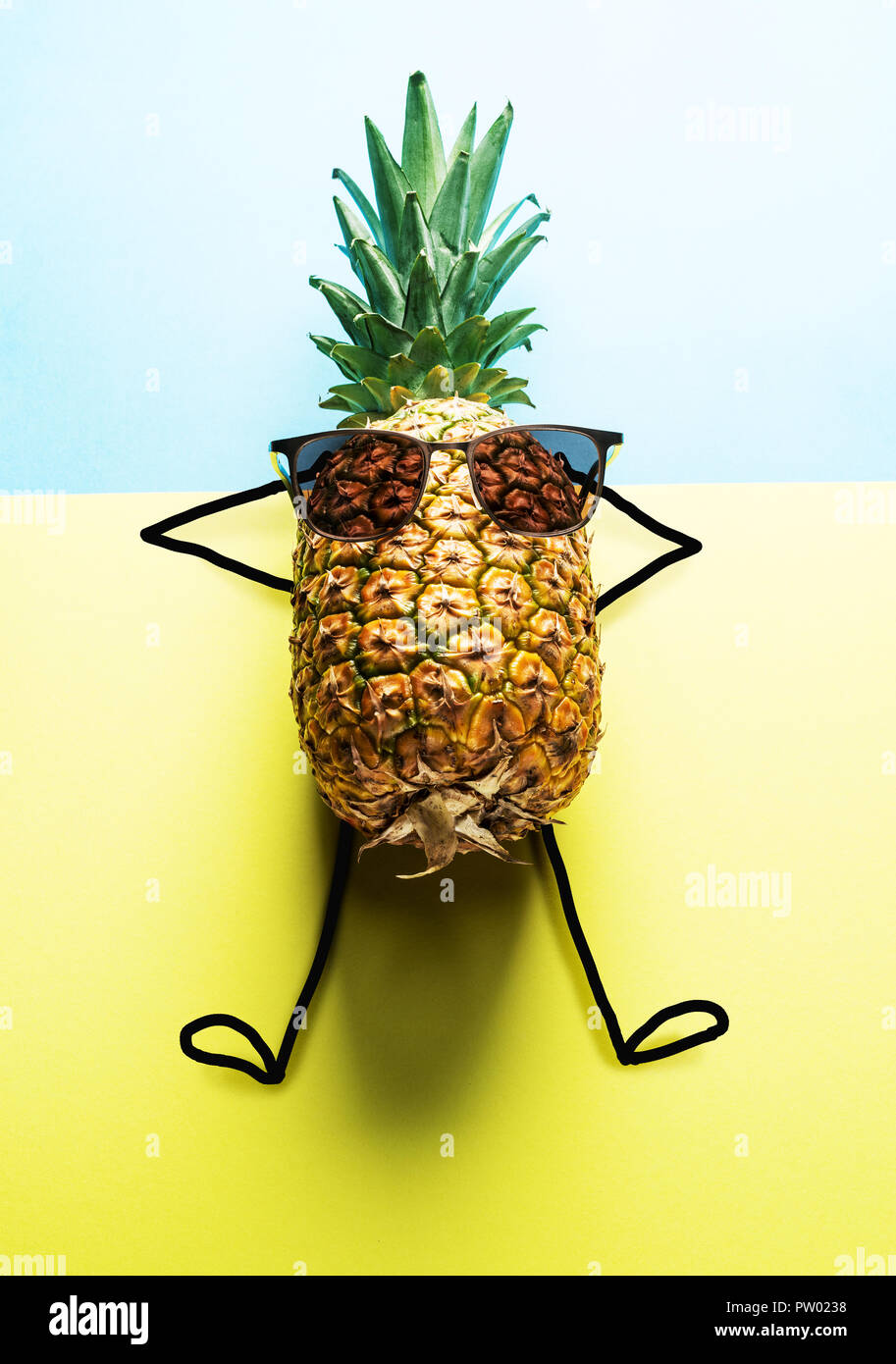 Pineapple man in sun glasses on blue-and-yellow background Stock