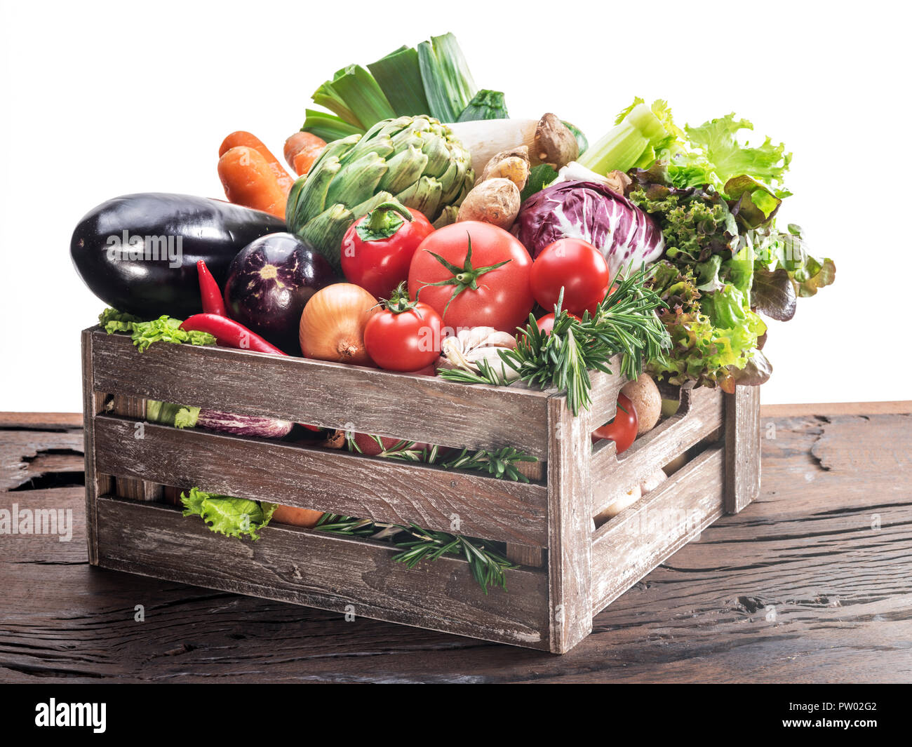 Fresh multi-colored vegetables in wooden crate. Stock Photo