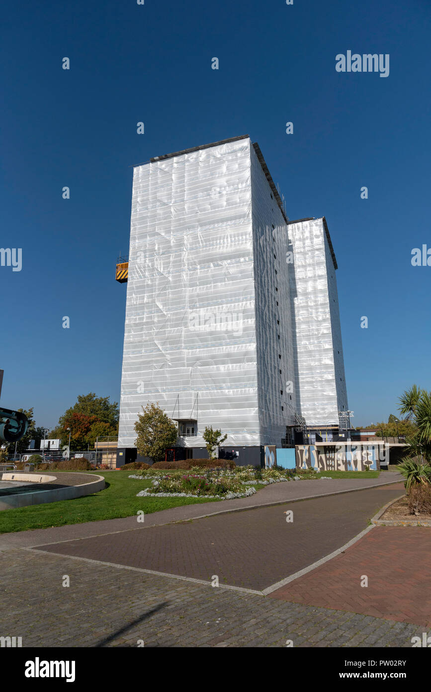 Highrise block of flats and apartments covered in plastic sheeting for weather protection whilst work is carried out on the building, Gosport, UK Stock Photo