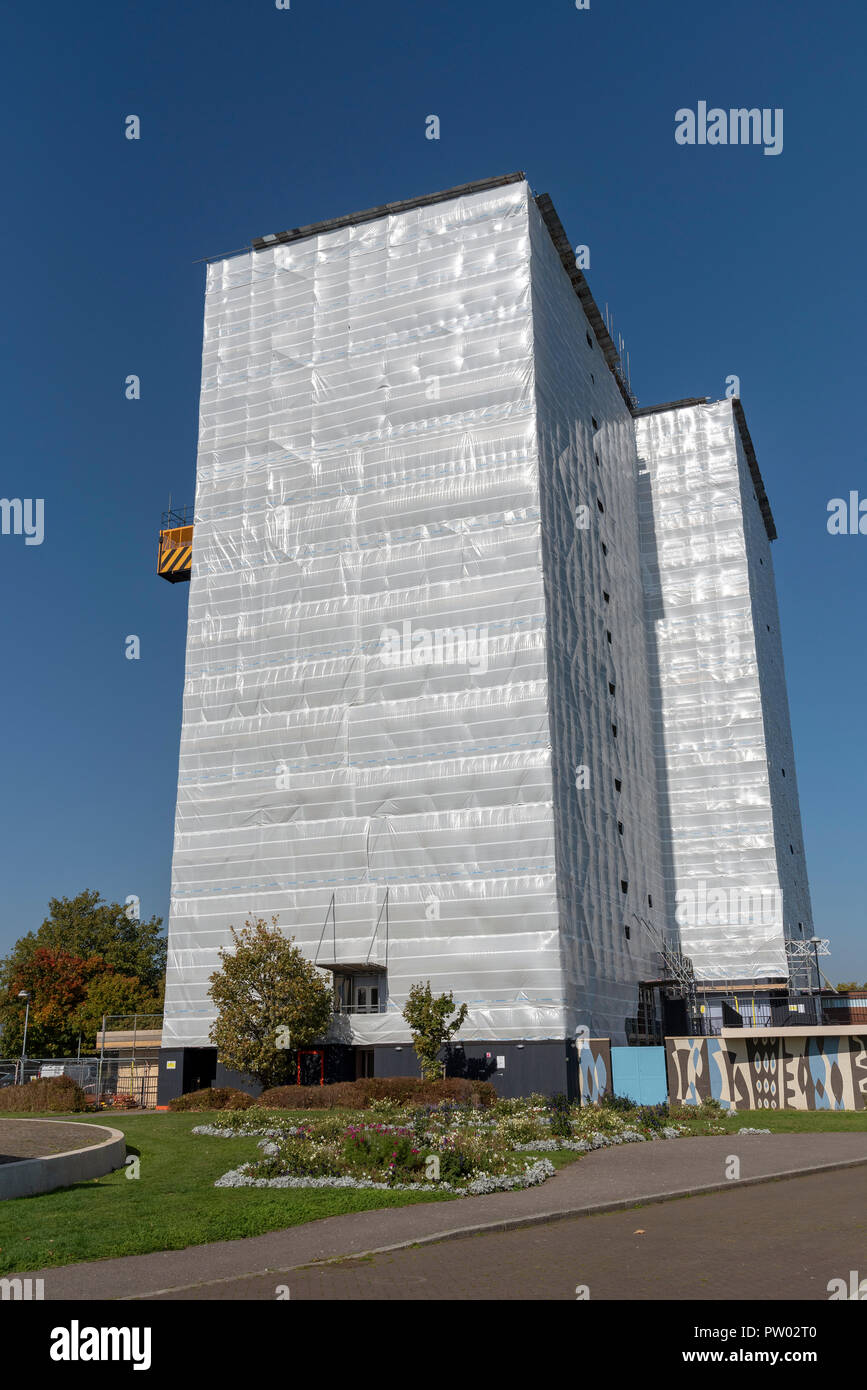 Highrise block of flats and apartments covered in plastic sheeting for weather protection whilst work is carried out on the building, Gosport, UK Stock Photo