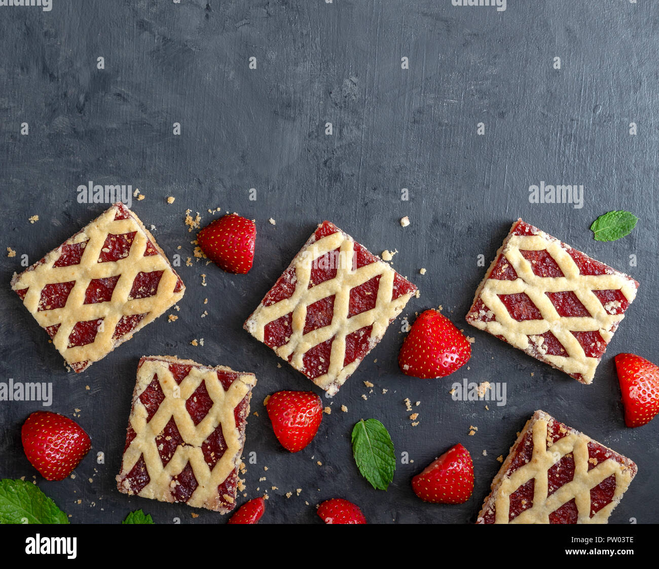 Strawberry cookies with strawberry fruits on dark background. Stock Photo