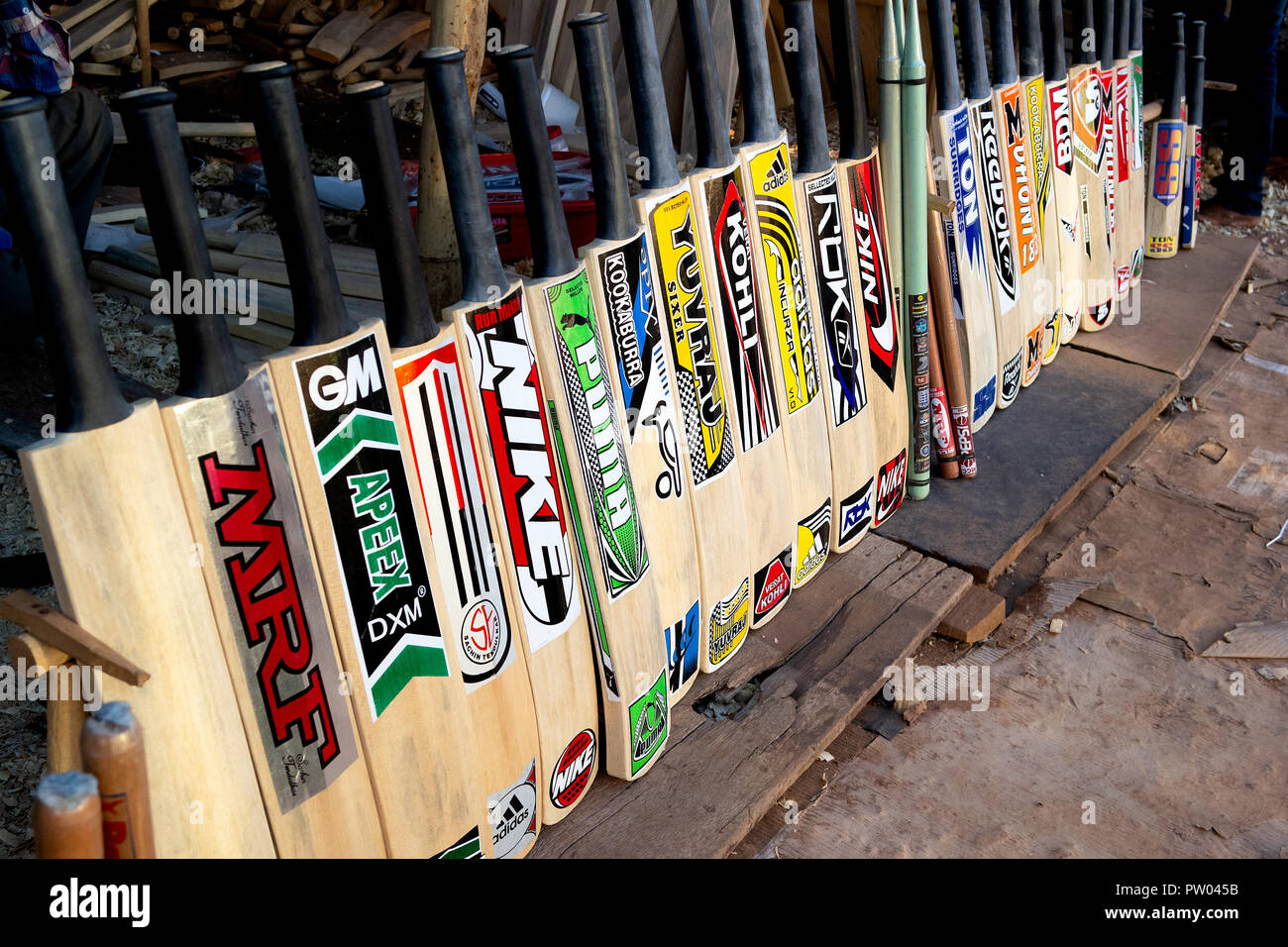 Hand made fake copies of popular cricket bats for sale on the road side, India. Stock Photo
