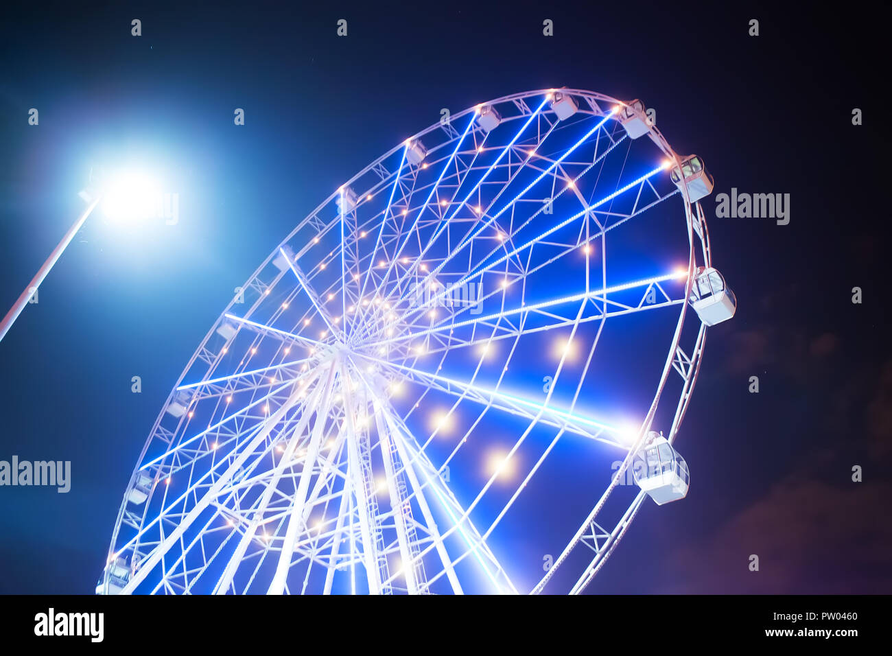 Carnival ride showing a spinning ferris wheel in action long exposure