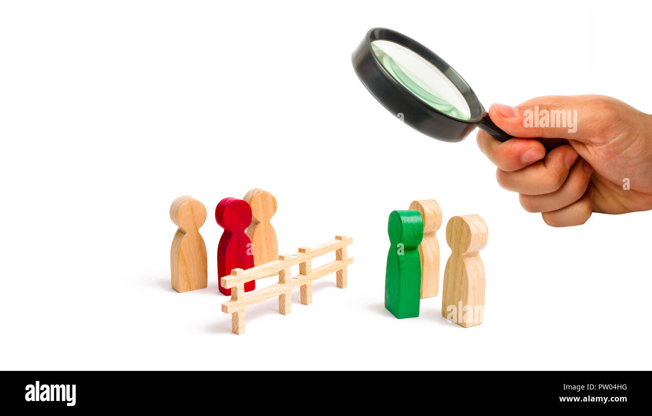Magnifying glass is looking at the wooden fence divides the two groups discussing the case. Termination and breakdown of relations, breaking ties. Con Stock Photo