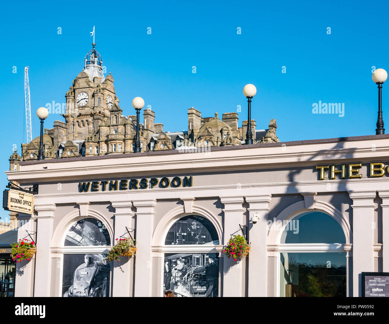 JD Wetherspoon The Booking Office pub, with Balmoral Hotel clock tower, Waverley Bridge, Edinburgh, Scotland, UK Stock Photo